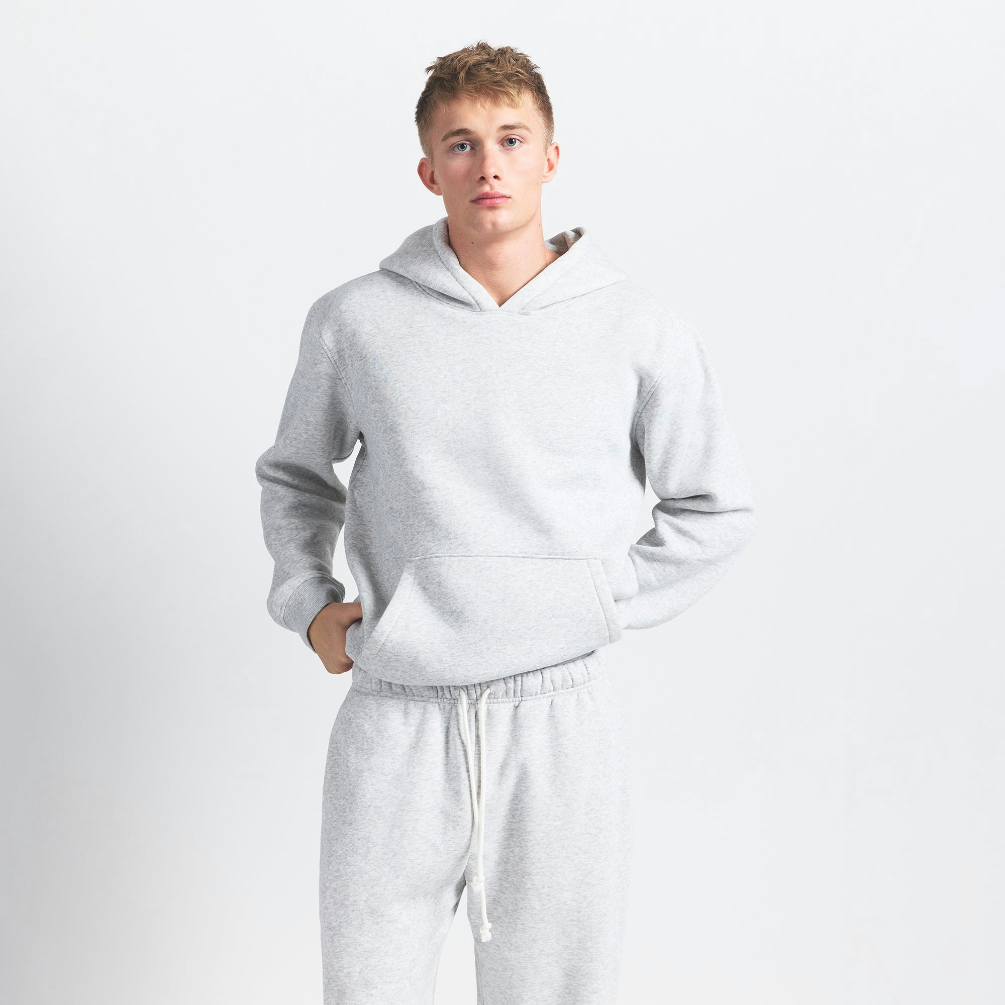 FLEECE LOUNGE MENS RELAXED HOODIE | LIGHT HEATHER GREY ON A MODEL FRONT VIEW @ | FOCUS: 0.0, 1.0, 0.9
