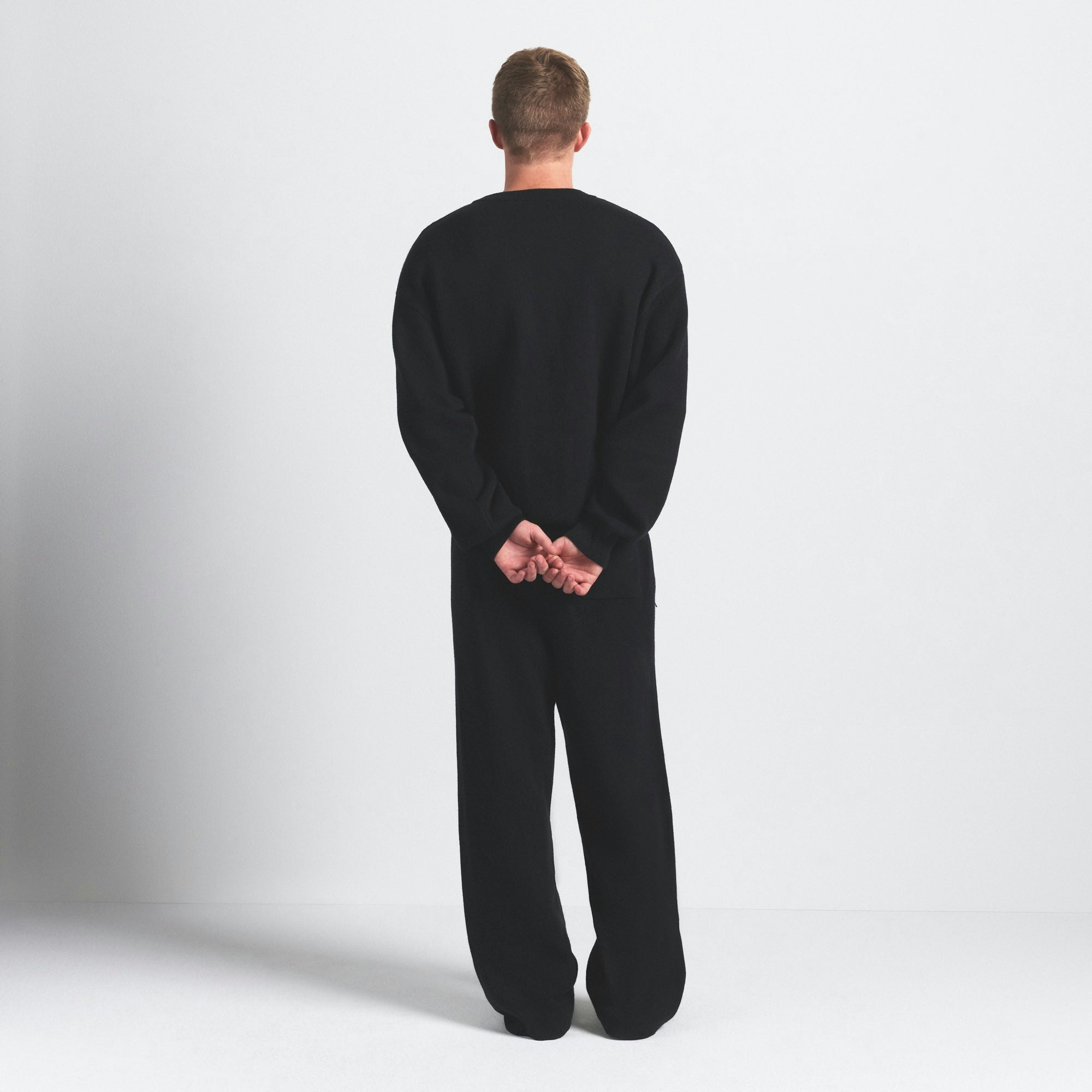 COTTON KNIT MENS SWEATER | OBSIDIAN ON A MODEL SIDE VIEW @ | FOCUS: 0.0, 1.0, 0.9