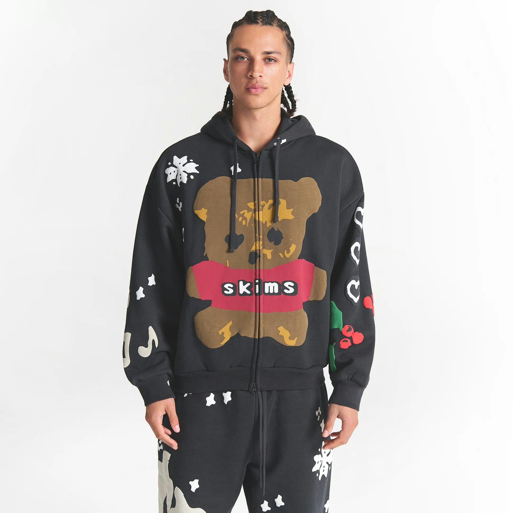 CACTUS PLANT FLEA MARKET X SKIMS HEAVYWEIGHT FLEECE MENS RELAXED ZIP UP HOODIE | ONYX TEDDY BEAR PRINT ON A MODEL FRONT VIEW @ | FOCUS: 0.0, 1.0, 0.9