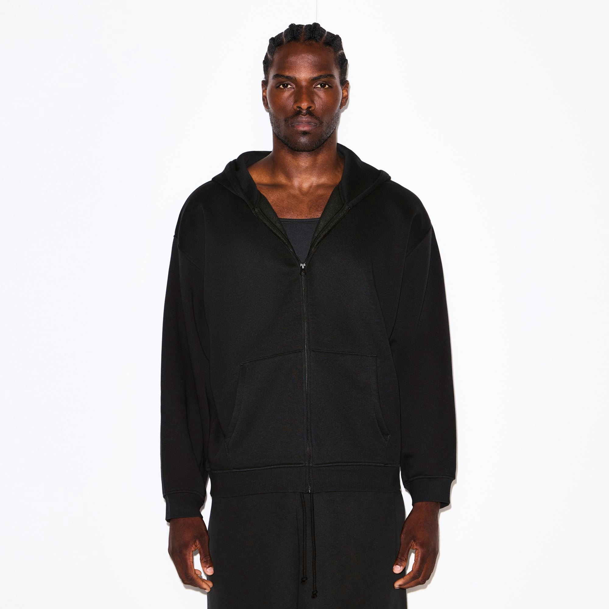 FLEECE LOUNGE MENS RELAXED ZIP UP HOODIE | WASHED ONYX ON A MODEL SIDE VIEW @ | FOCUS: 0.0, 1.0, 0.9