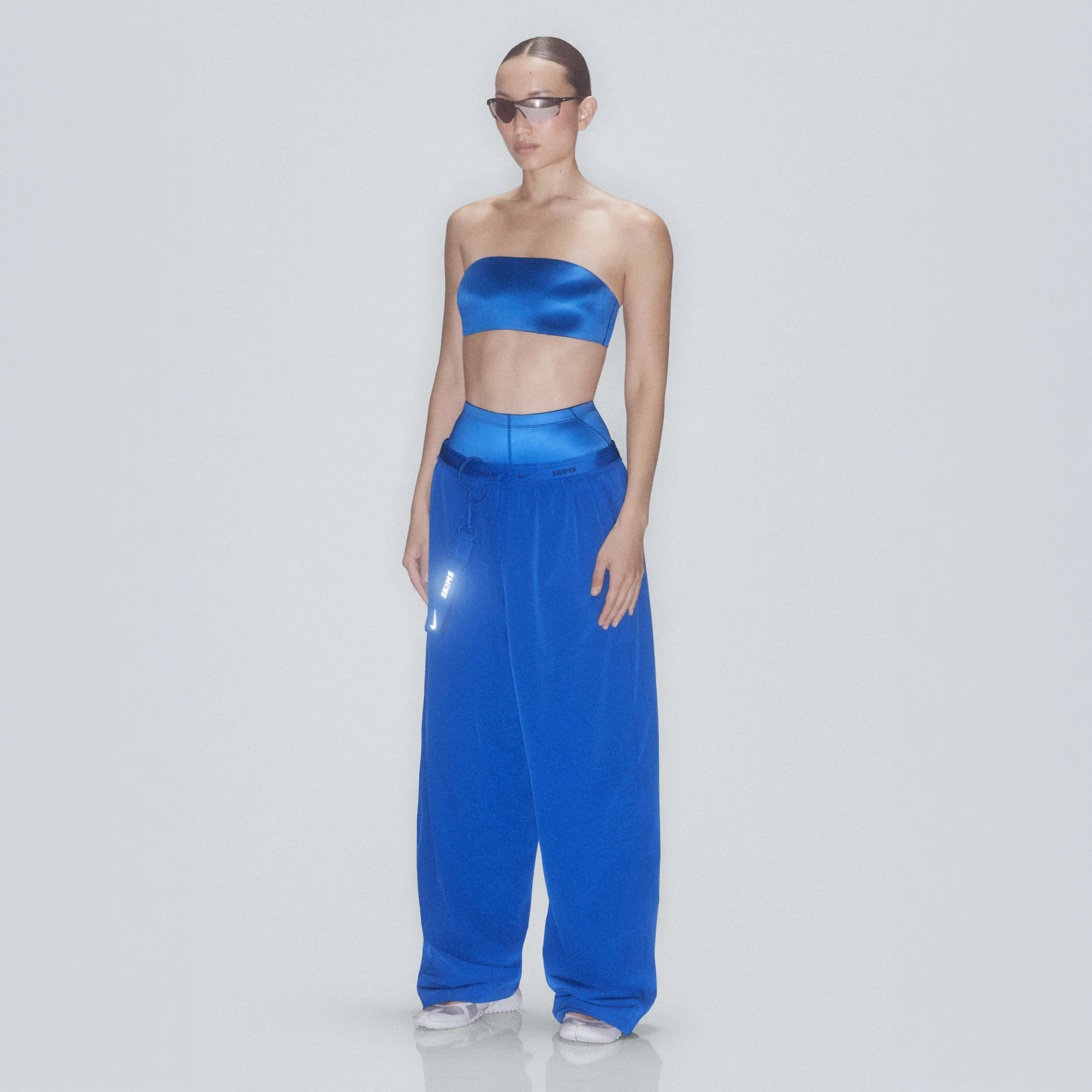 NikeSKIMS STRETCH NYLON OVERSIZED PANT | COBALT & LAYS FLAT ON A WHITE BACKGROUND | FLT