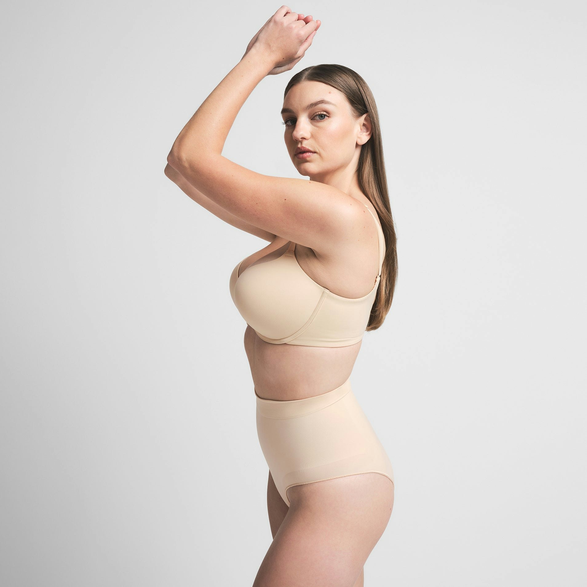 SEAMLESS SCULPT MID WAIST BRIEF | SAND ON A MODEL SIDE VIEW | FOCUS: 0.0, 1.0, 0.9