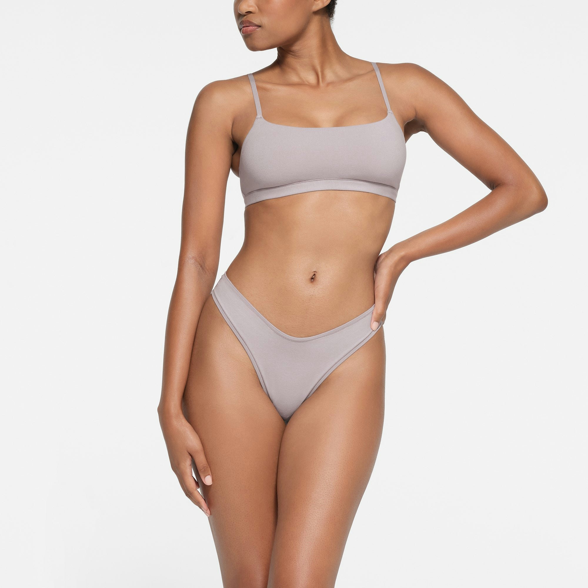 COTTON JERSEY DIPPED THONG | OYSTER ON A MODEL FRONT VIEW