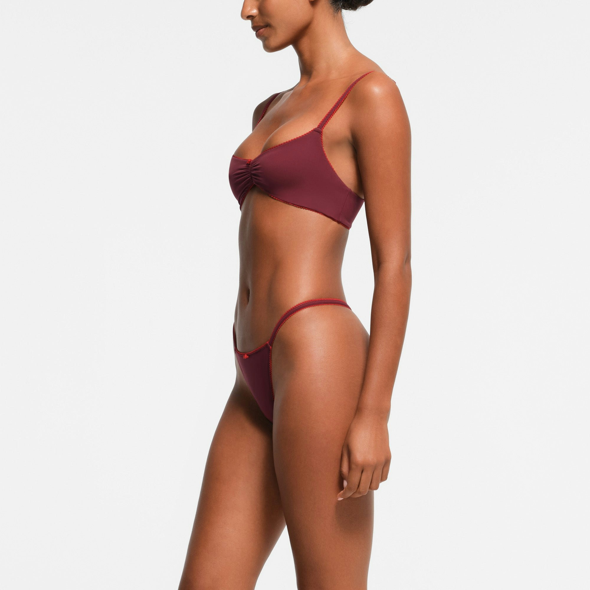 FITS EVERYBODY PICOT TRIM STRING THONG | WINE CONTRAST ON A MODEL SIDE VIEW
