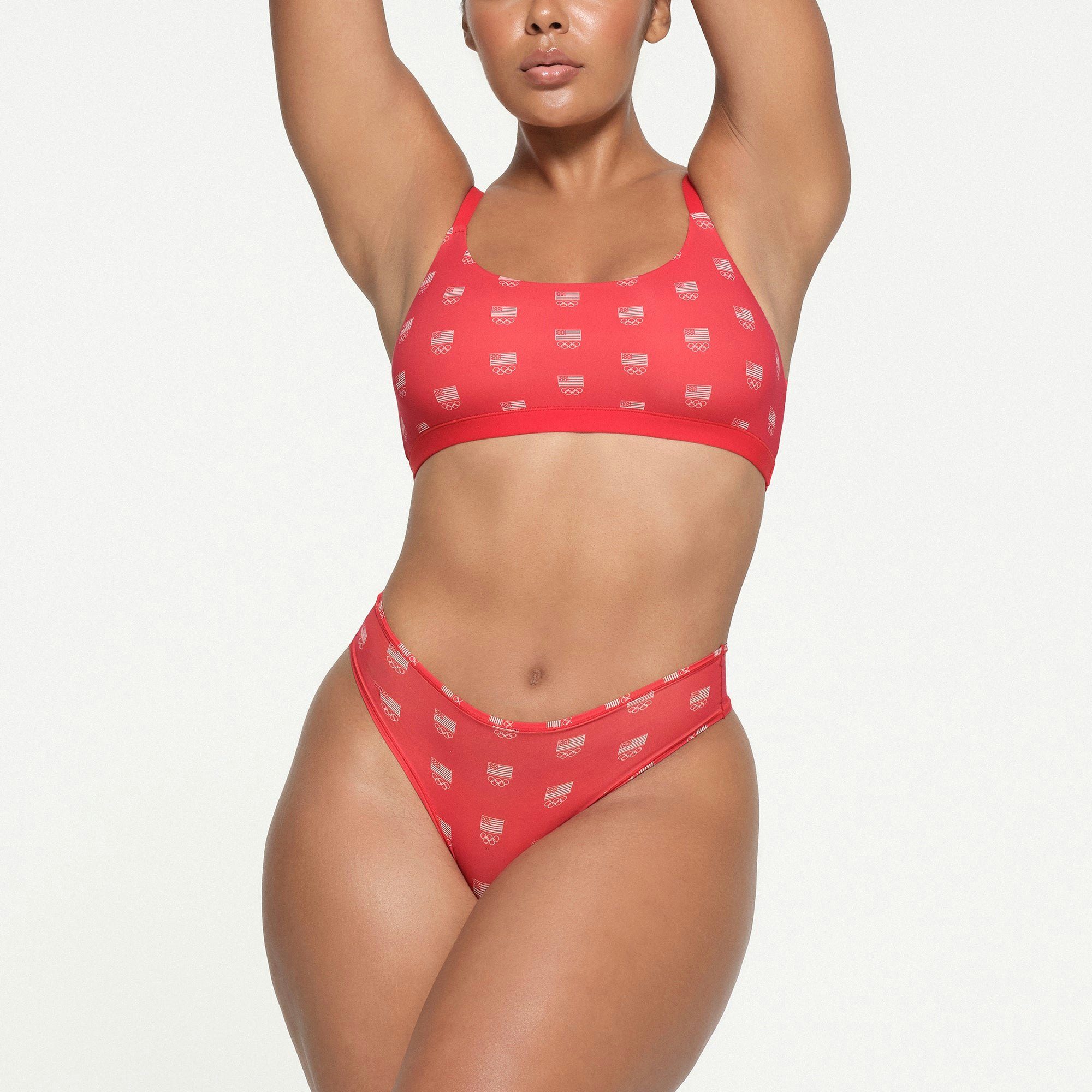 SKIMS FOR TEAM USA FITS EVERYBODY OLYMPIC DIPPED FRONT THONG | RED ON A MODEL FRONT VIEW