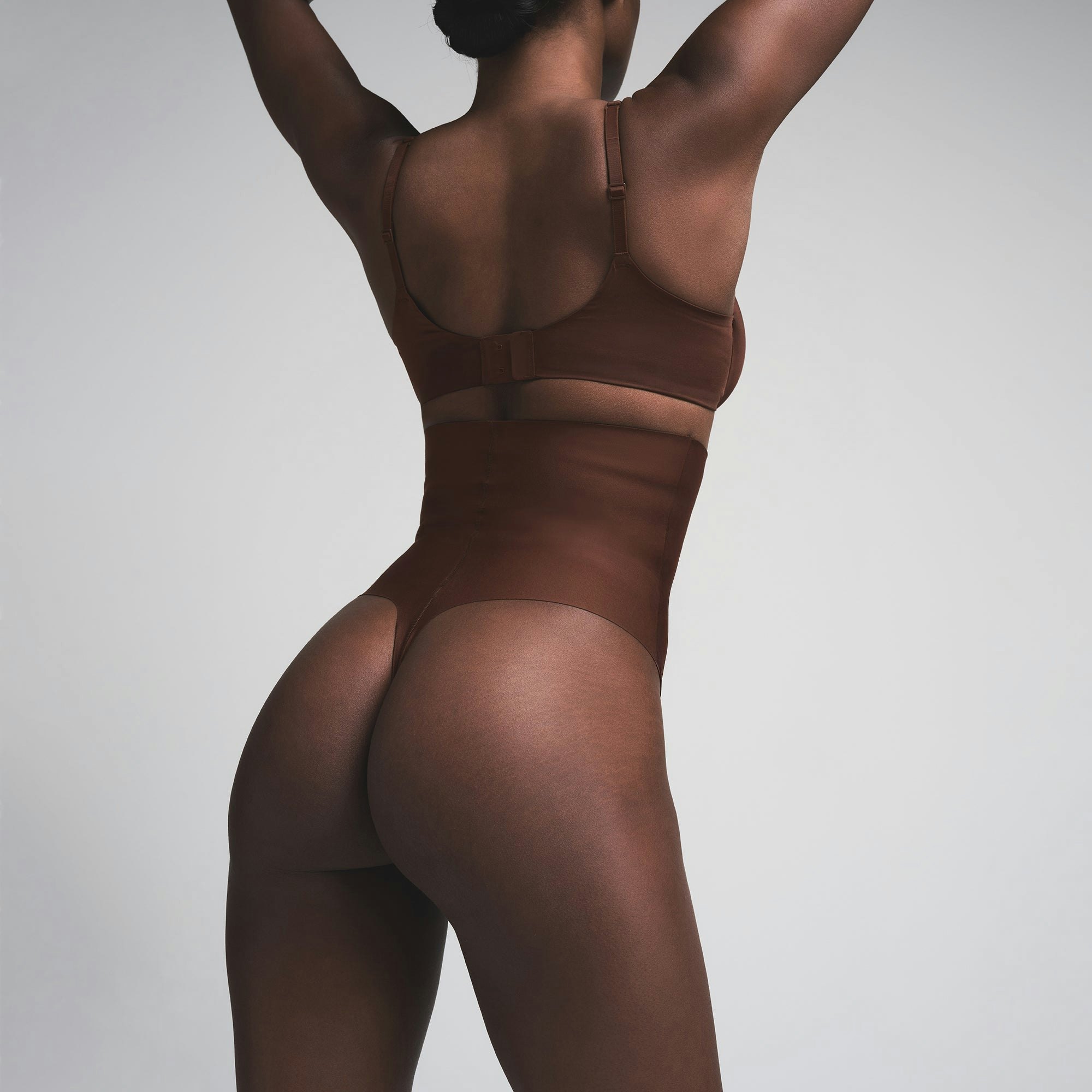 SKIMS BODY CORE SCULPT HIGH-WAISTED THONG | COCOA  ON A MODEL BACK VIEW | FOCUS: 0.0, 1.0, 0.9