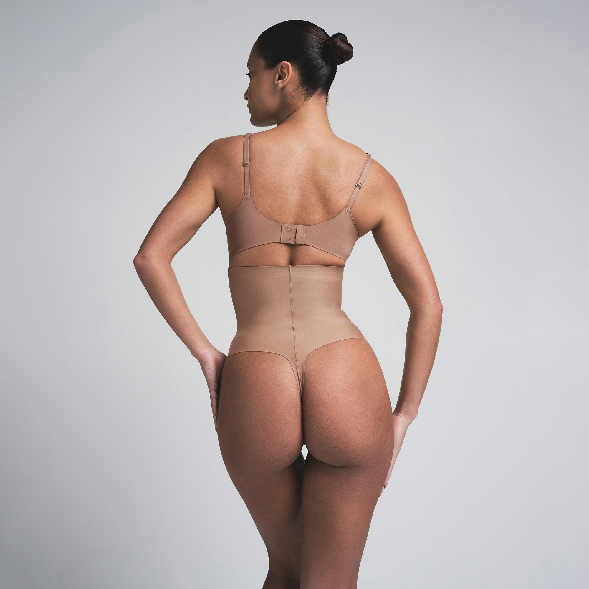 SKIMS BODY CORE SCULPT HIGH-WAISTED THONG | SIENNA ON A MODEL BACK VIEW | FOCUS: 0.0, 1.0, 0.9