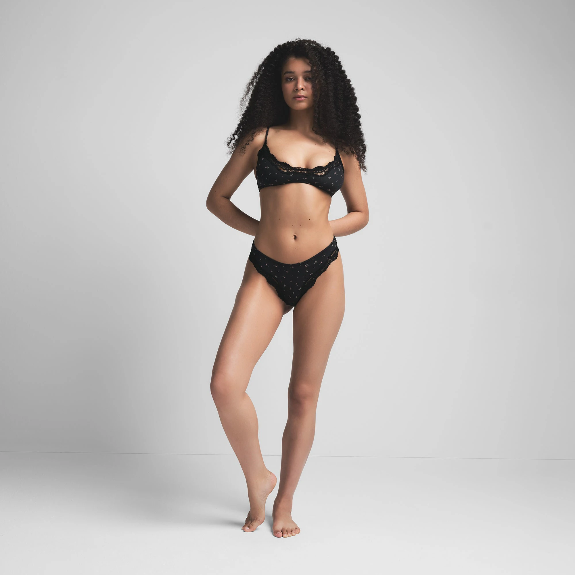 FITS EVERYBODY LACE TANGA | ONYX ROSEBUD PRINT ON A MODEL FRONT VIEW | FOCUS: 0.0, 1.0, 0.9