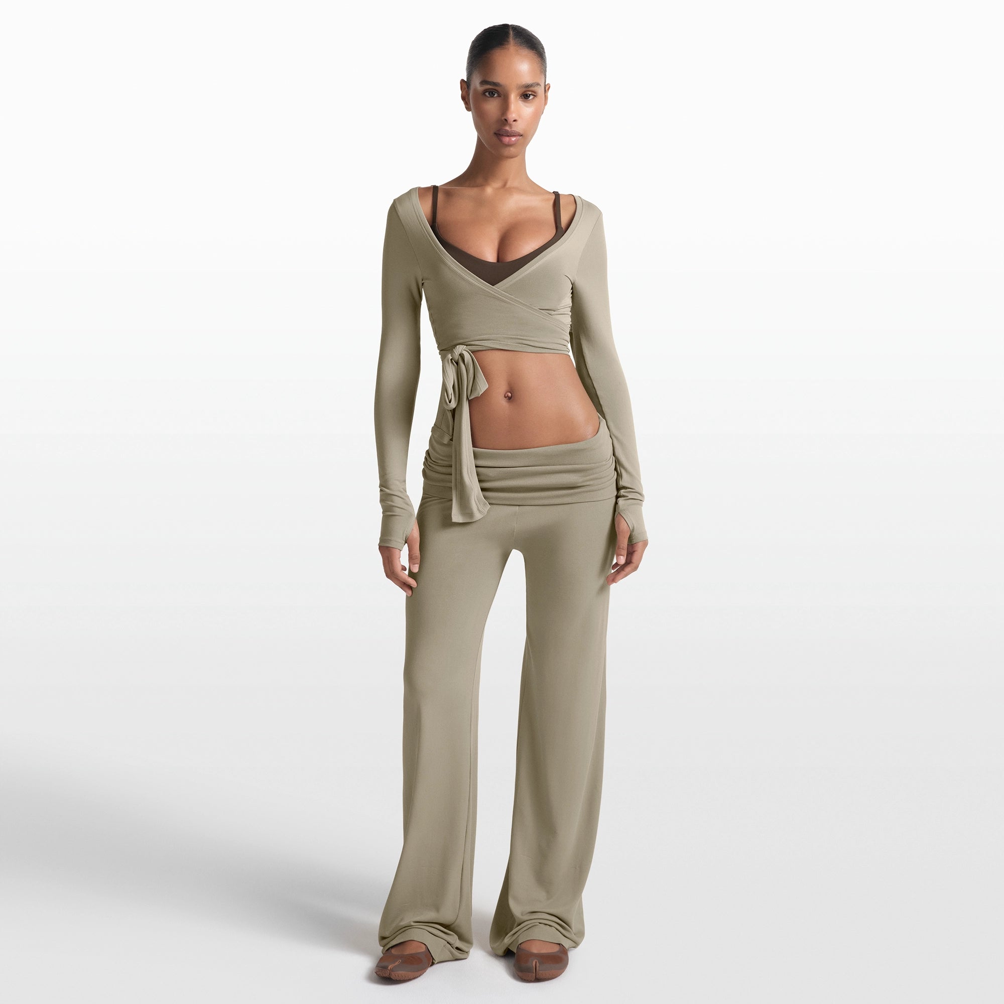 NikeSKIMS STRETCH KNIT FOLDOVER WIDE LEG PANT | DUNE ON A MODEL FRONT VIEW @ | FOCUS: 0.0, 1.0, 0.9