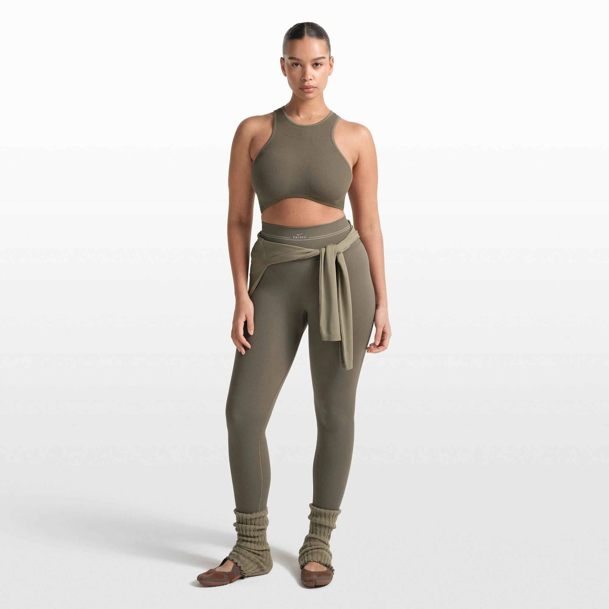 NikeSKIMS RIBBED SEAMLESS 26" LEGGING | DUSTY OAKMOSS ON A MODEL FRONT VIEW @ | FOCUS: 0.0, 1.0, 0.9