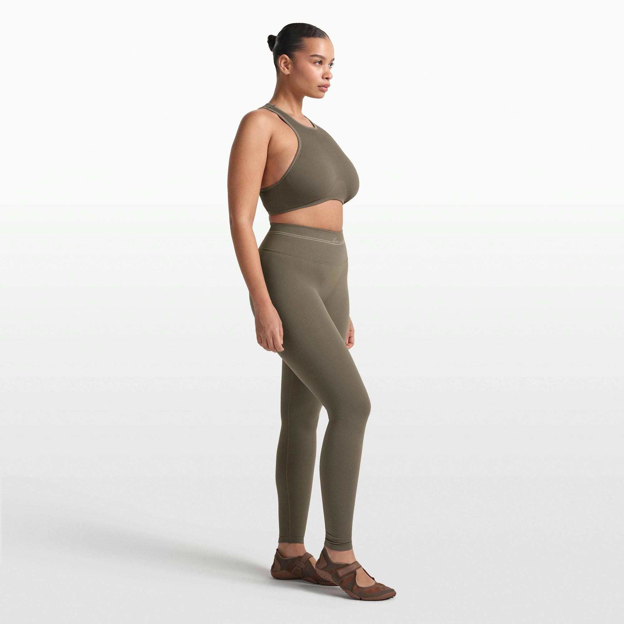 NikeSKIMS RIBBED SEAMLESS 26" LEGGING | DUSTY OAKMOSS ON A MODEL FRONT VIEW @ | FOCUS: 0.0, 1.0, 0.9