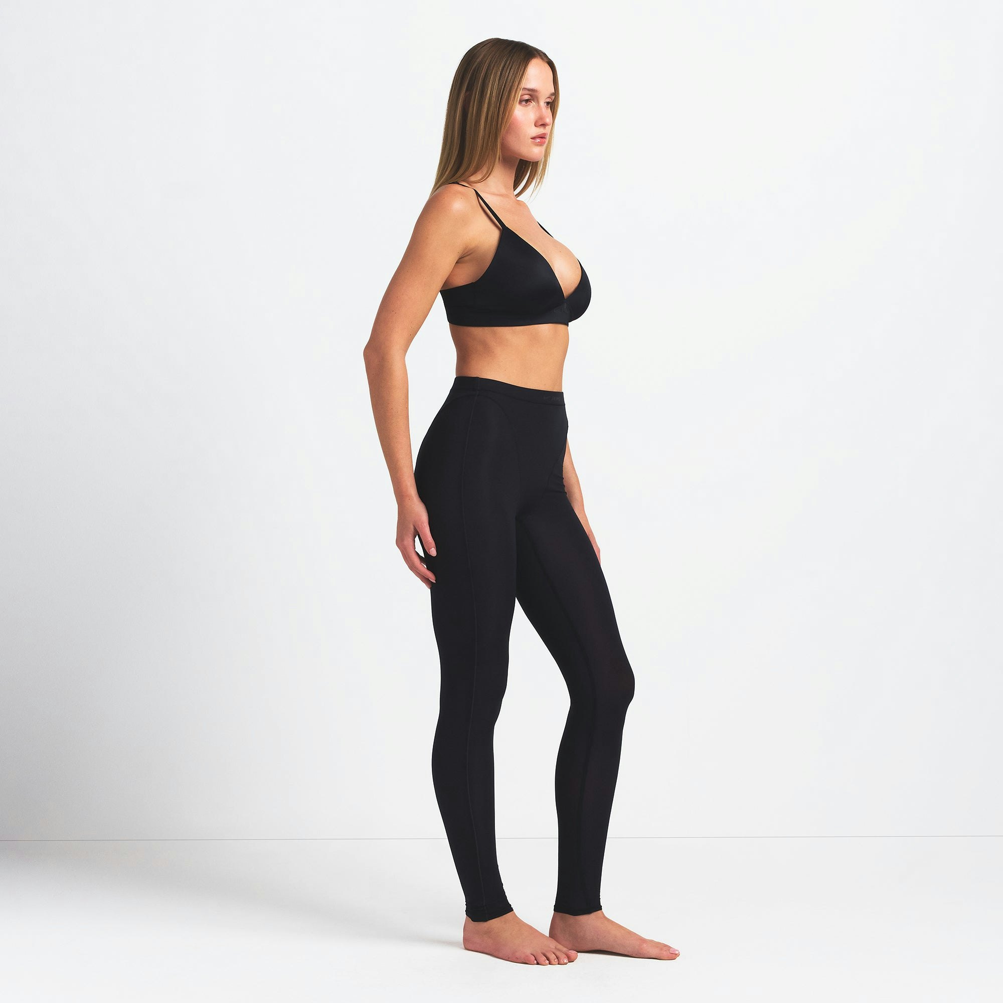 NikeSKIMS WEIGHTLESS LAYERS V-LINE 26" LEGGING | OBSIDIAN ON A MODEL SIDE VIEW