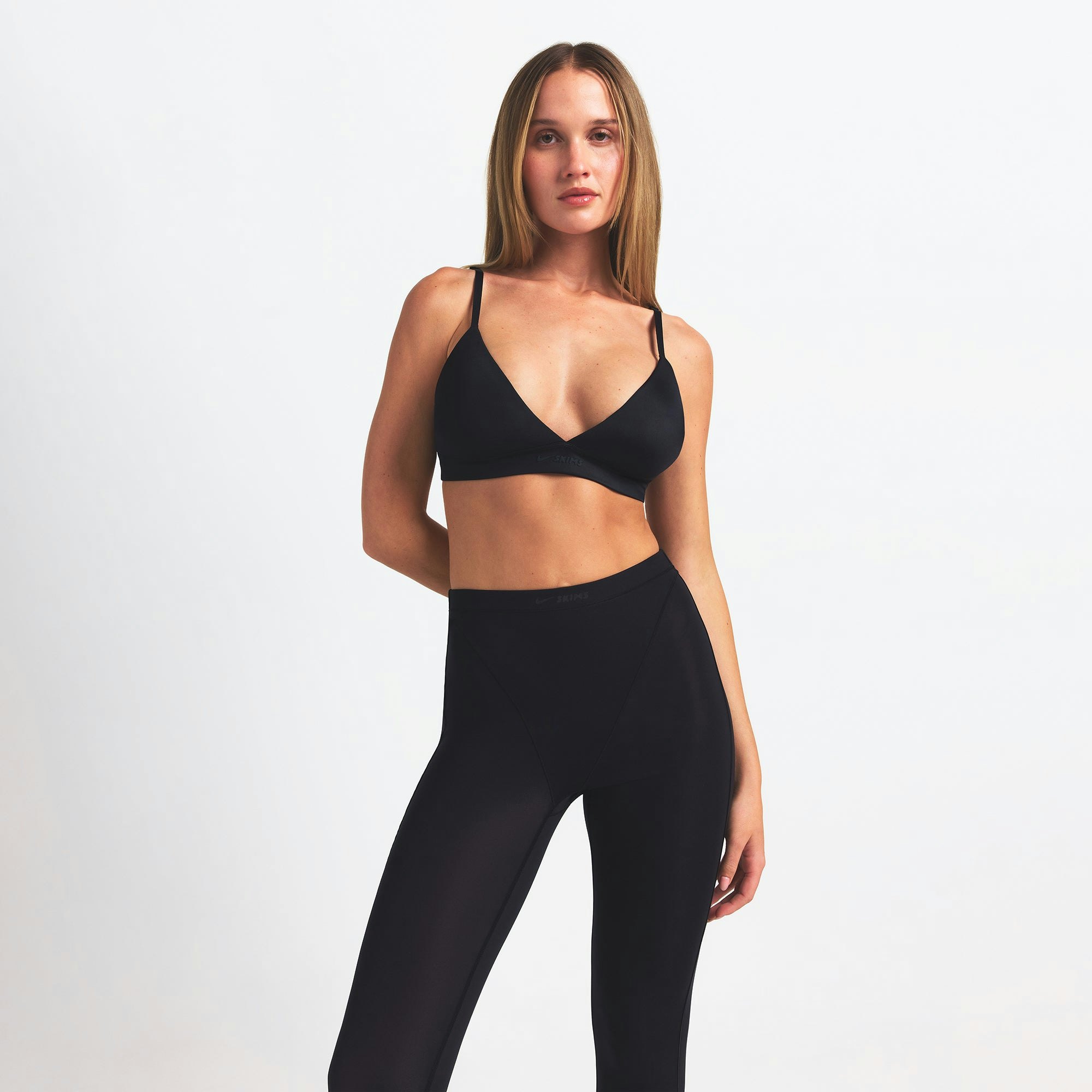 NikeSKIMS WEIGHTLESS LAYERS V-LINE 26" LEGGING | OBSIDIAN ON A MODEL FRONT VIEW