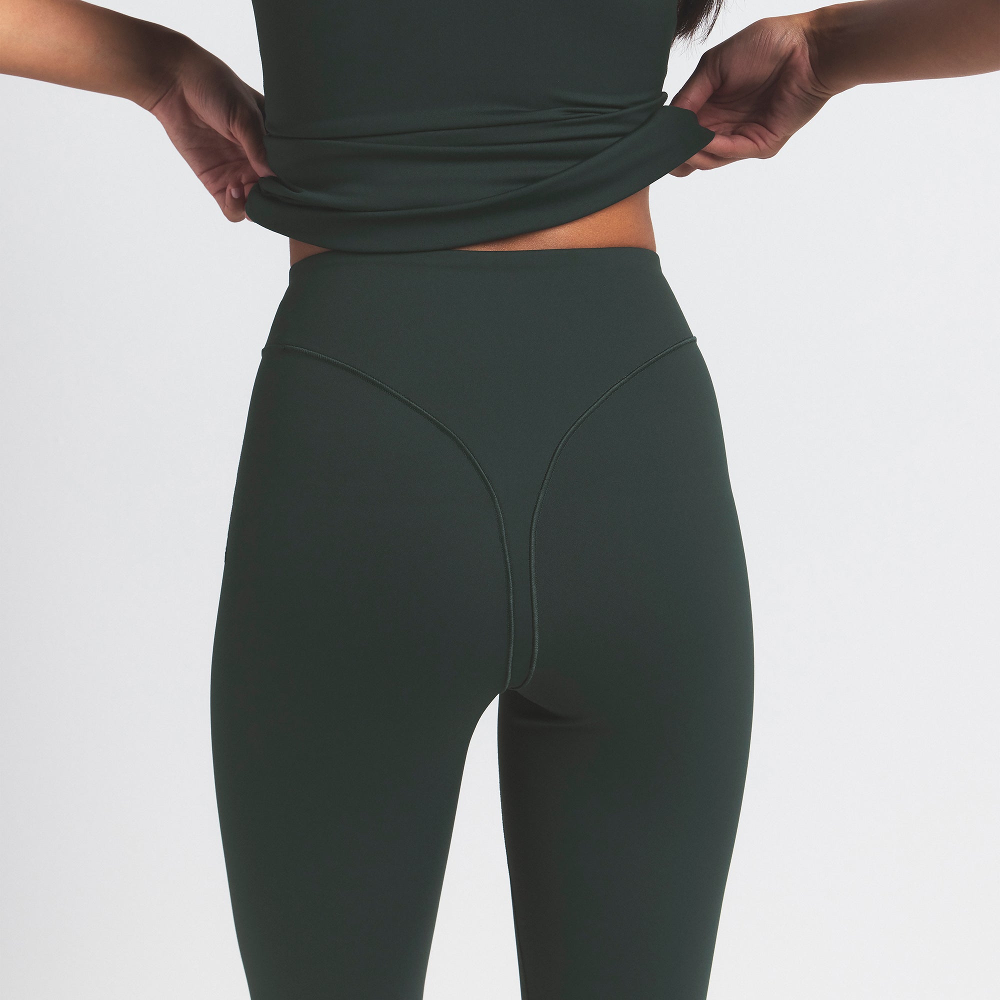 NikeSKIMS MATTE V-LINE 39" STRAIGHT LEGGING | DARK TEAL ON A MODEL SIDE VIEW @ | FOCUS: 0.0, 1.0, 0.9