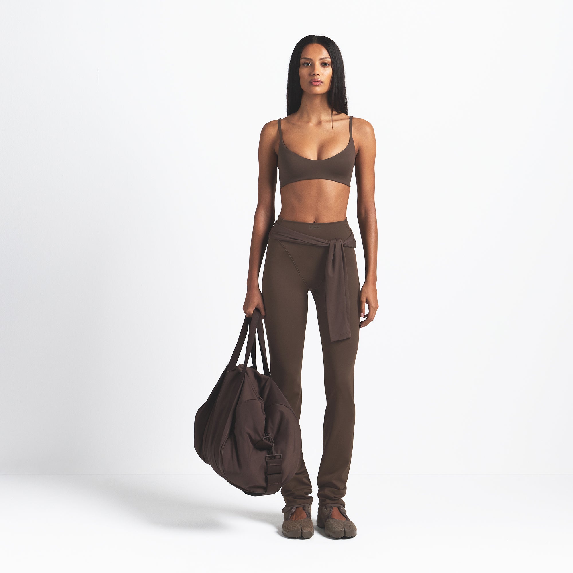 NikeSKIMS MATTE V-LINE 39" STRAIGHT LEGGING | DARK SEPIA ON A MODEL FRONT VIEW