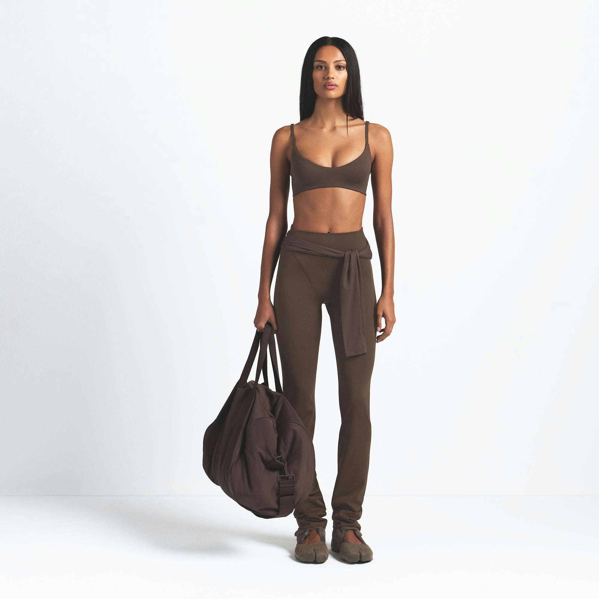 NikeSKIMS MATTE V-LINE 39" STRAIGHT LEGGING | DARK SEPIA ON A MODEL FRONT VIEW