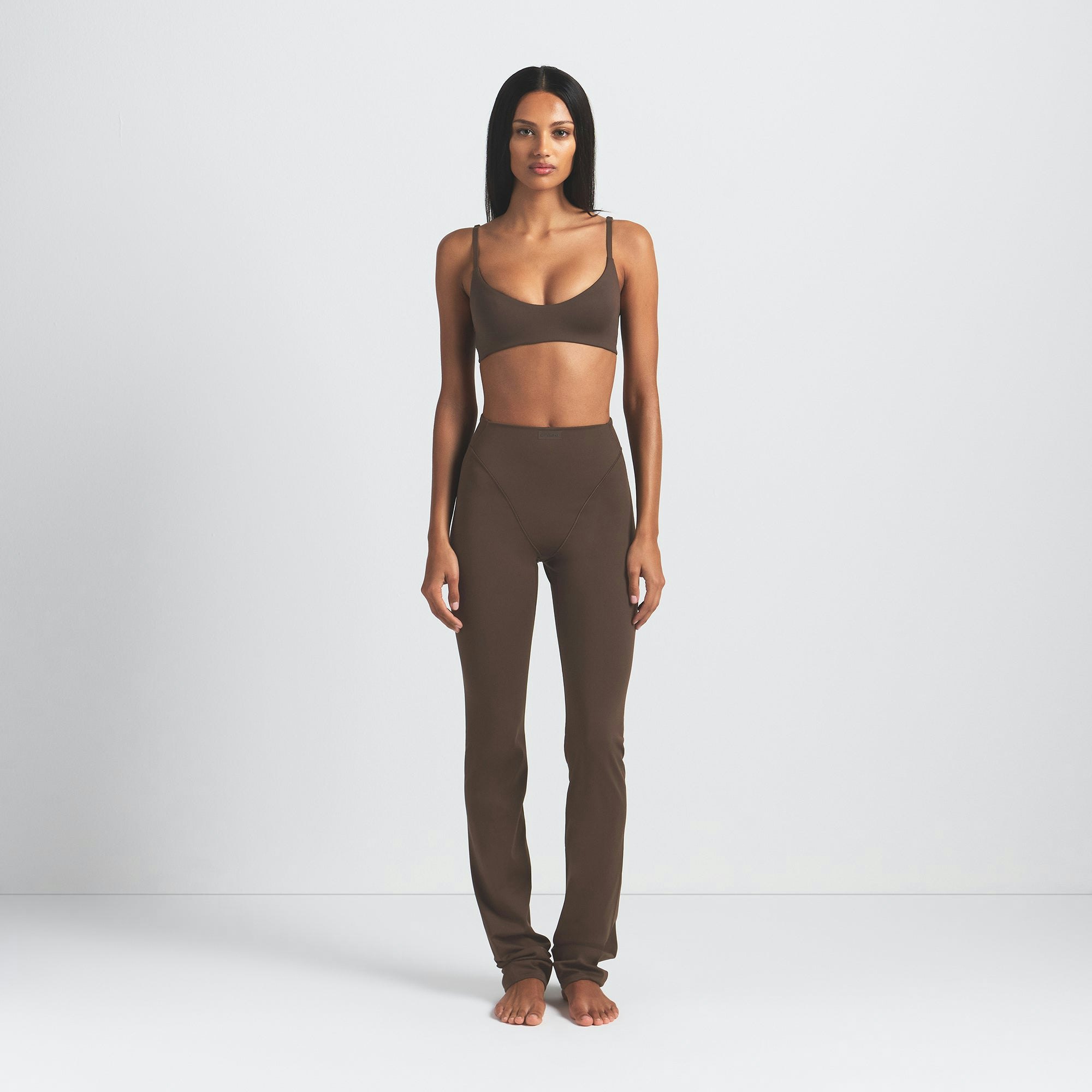 NikeSKIMS MATTE V-LINE 39" STRAIGHT LEGGING | DARK SEPIA ON A MODEL FRONT VIEW