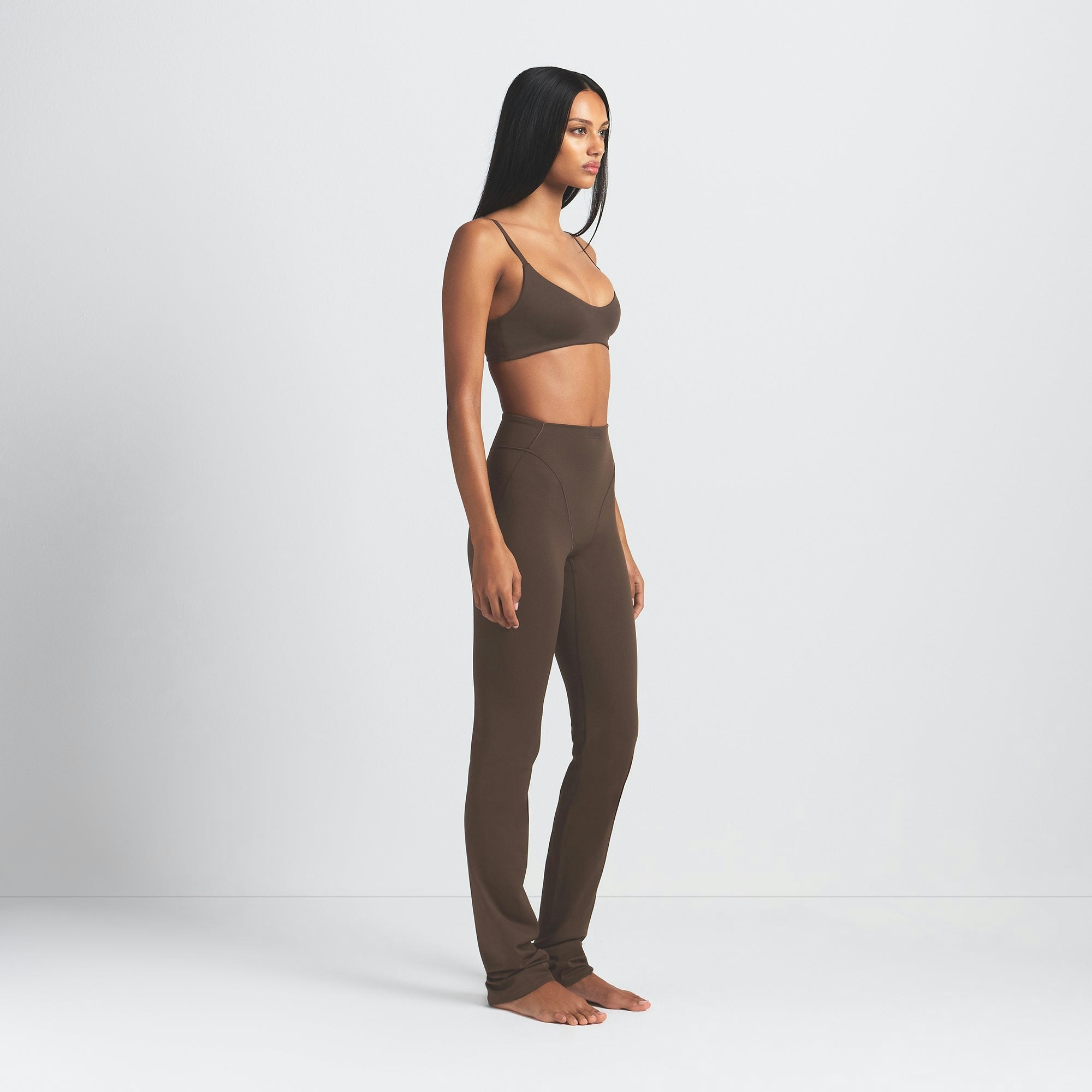 NikeSKIMS MATTE V-LINE 39" STRAIGHT LEGGING | DARK SEPIA ON A MODEL SIDE VIEW