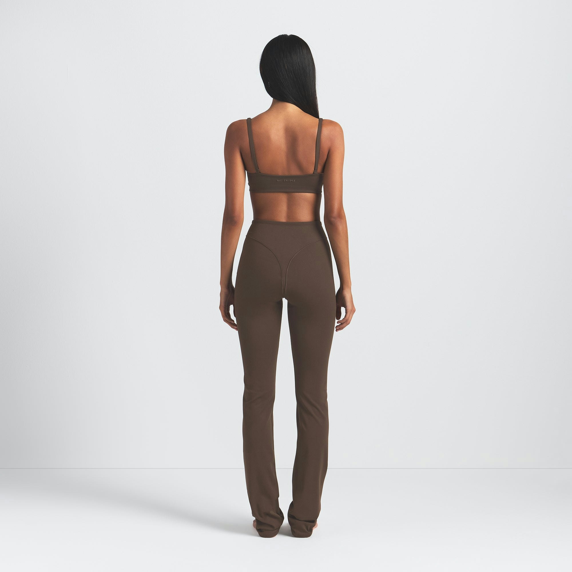 NikeSKIMS MATTE V-LINE 39" STRAIGHT LEGGING | DARK SEPIA ON A MODEL BACK VIEW