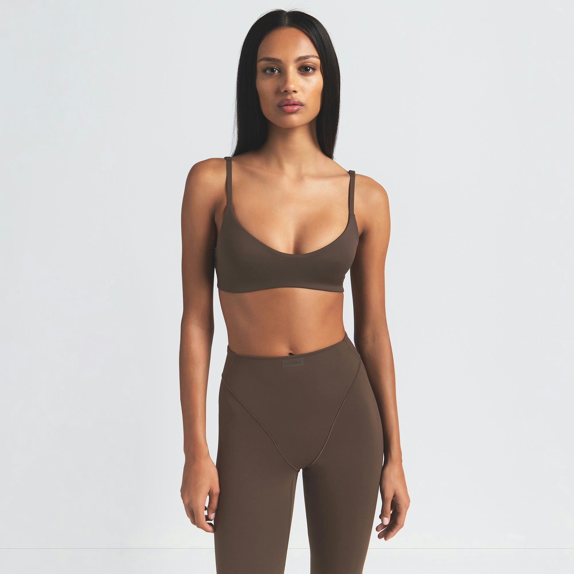 NikeSKIMS MATTE V-LINE 39" STRAIGHT LEGGING | DARK SEPIA ON A MODEL FRONT VIEW
