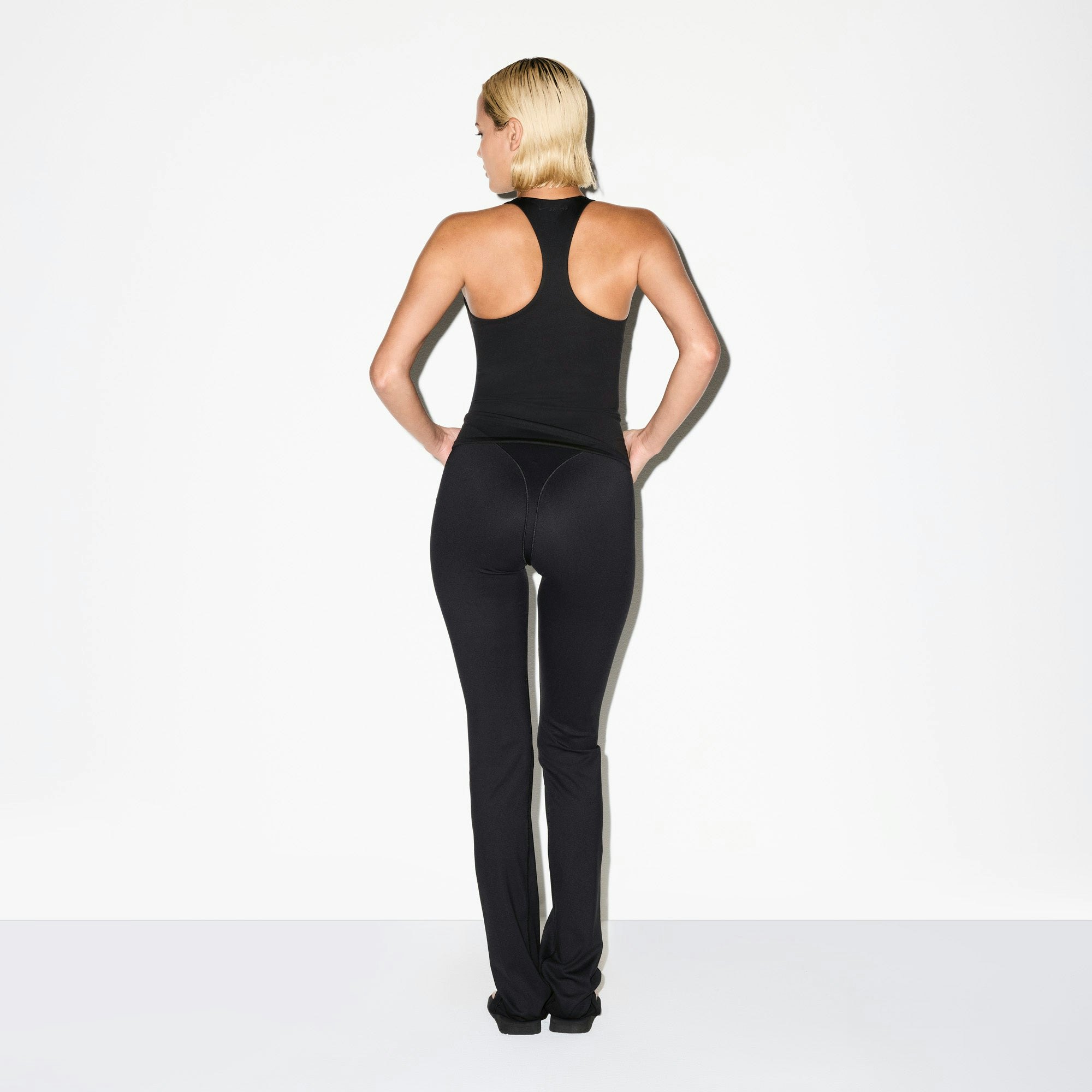 NikeSKIMS MATTE V-LINE 39" STRAIGHT LEGGING | OBSIDIAN ON A MODEL BACK VIEW