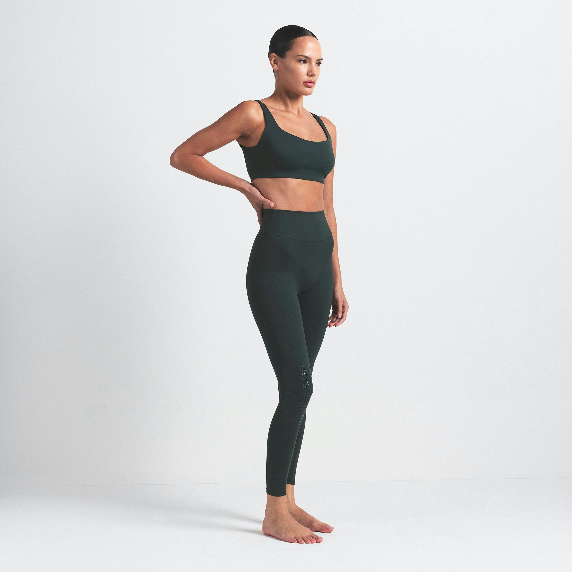 NikeSKIMS MATTE KNEE GRIP 26" LEGGING | DARK TEAL ON A MODEL SIDE VIEW @ | FOCUS: 0.0, 1.0, 0.9