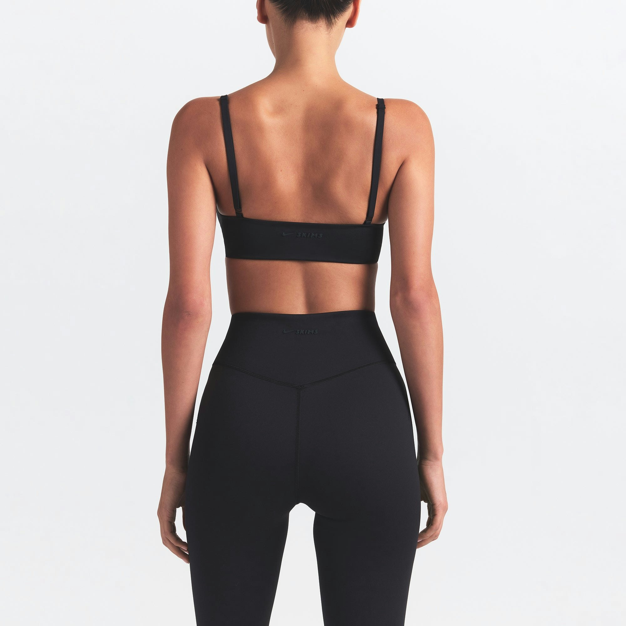 NikeSKIMS MATTE KNEE GRIP 26" LEGGING | OBSIDIAN ON A MODEL BACK VIEW @ | FOCUS: 0.0, 1.0, 0.9