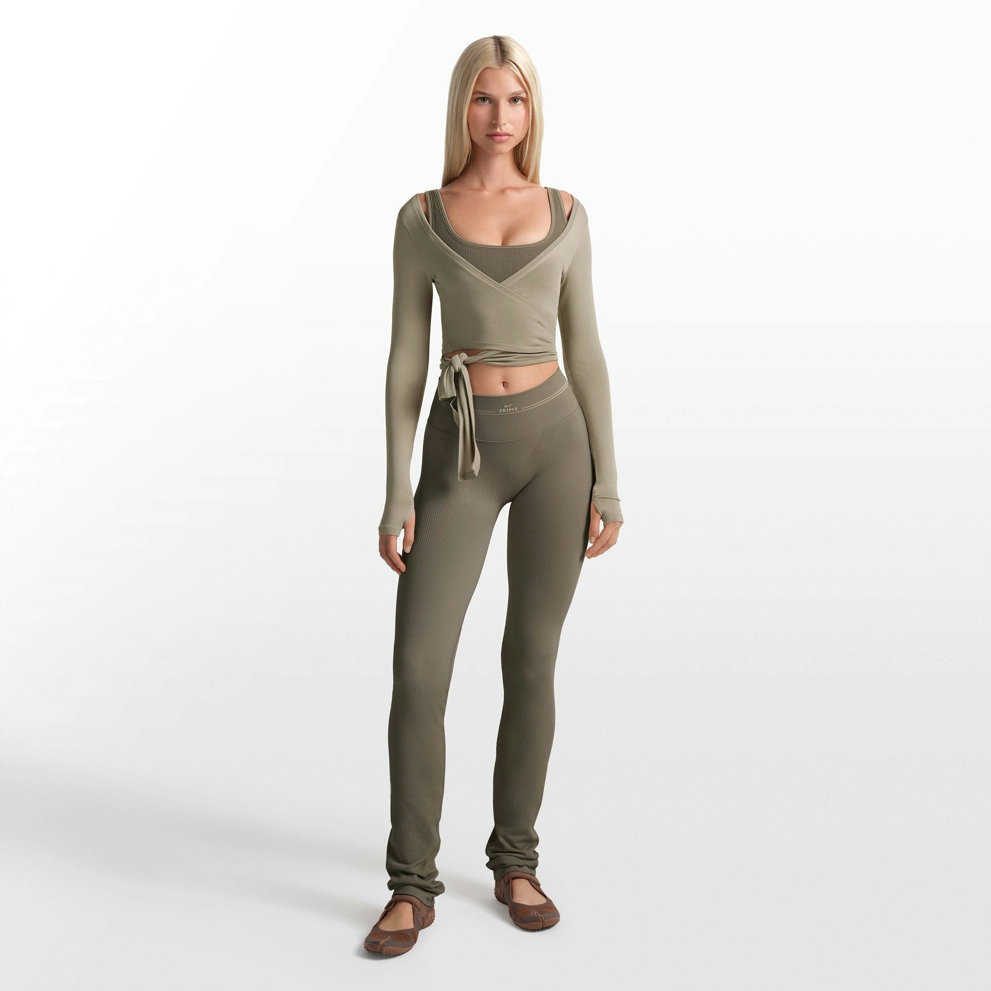 NikeSKIMS RIBBED SEAMLESS 34" STRAIGHT LEGGING | DUSTY OAKMOSS ON A MODEL FRONT VIEW @ | FOCUS: 0.0, 1.0, 0.9