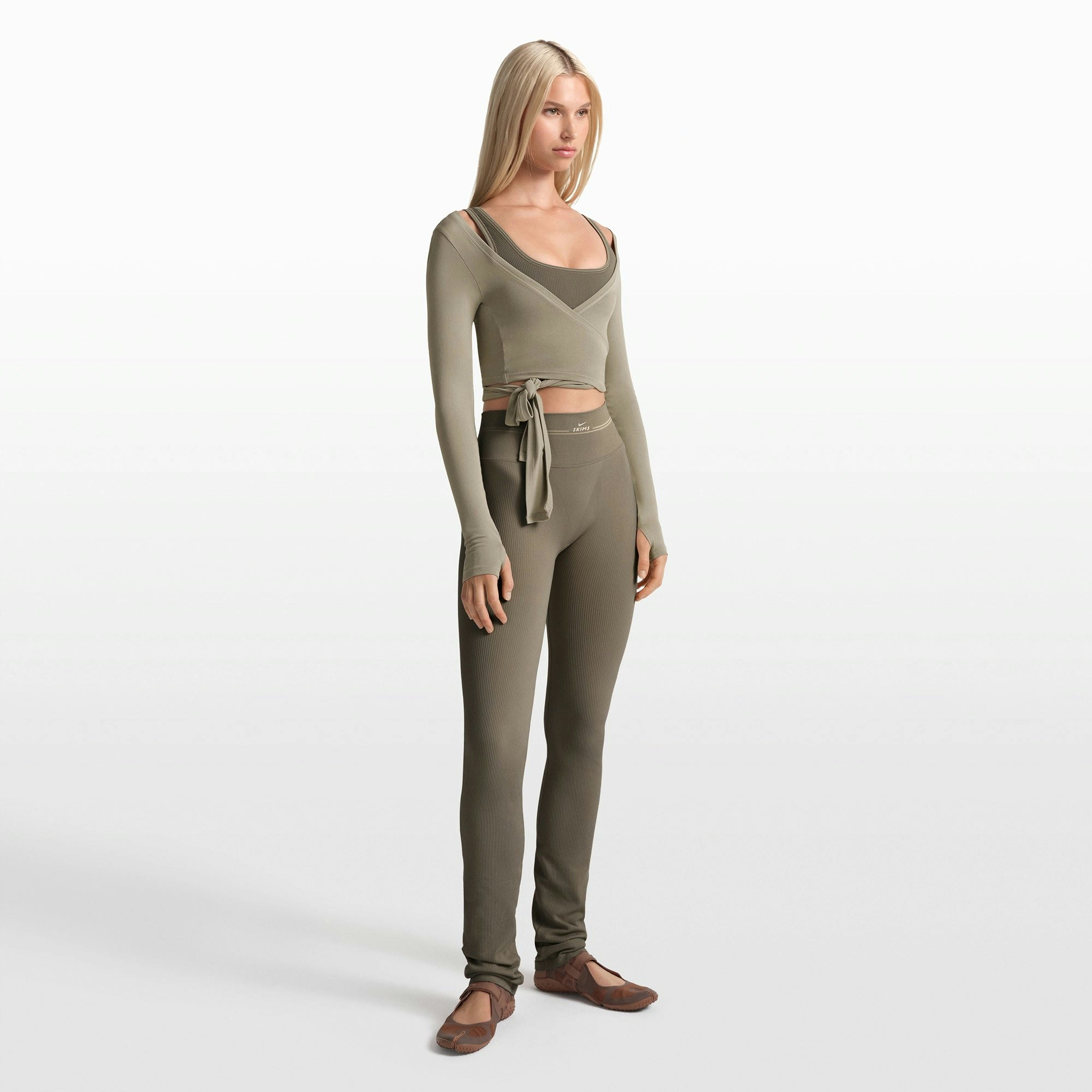 NikeSKIMS RIBBED SEAMLESS 34" STRAIGHT LEGGING | DUSTY OAKMOSS ON A MODEL FRONT VIEW @ | FOCUS: 0.0, 1.0, 0.9