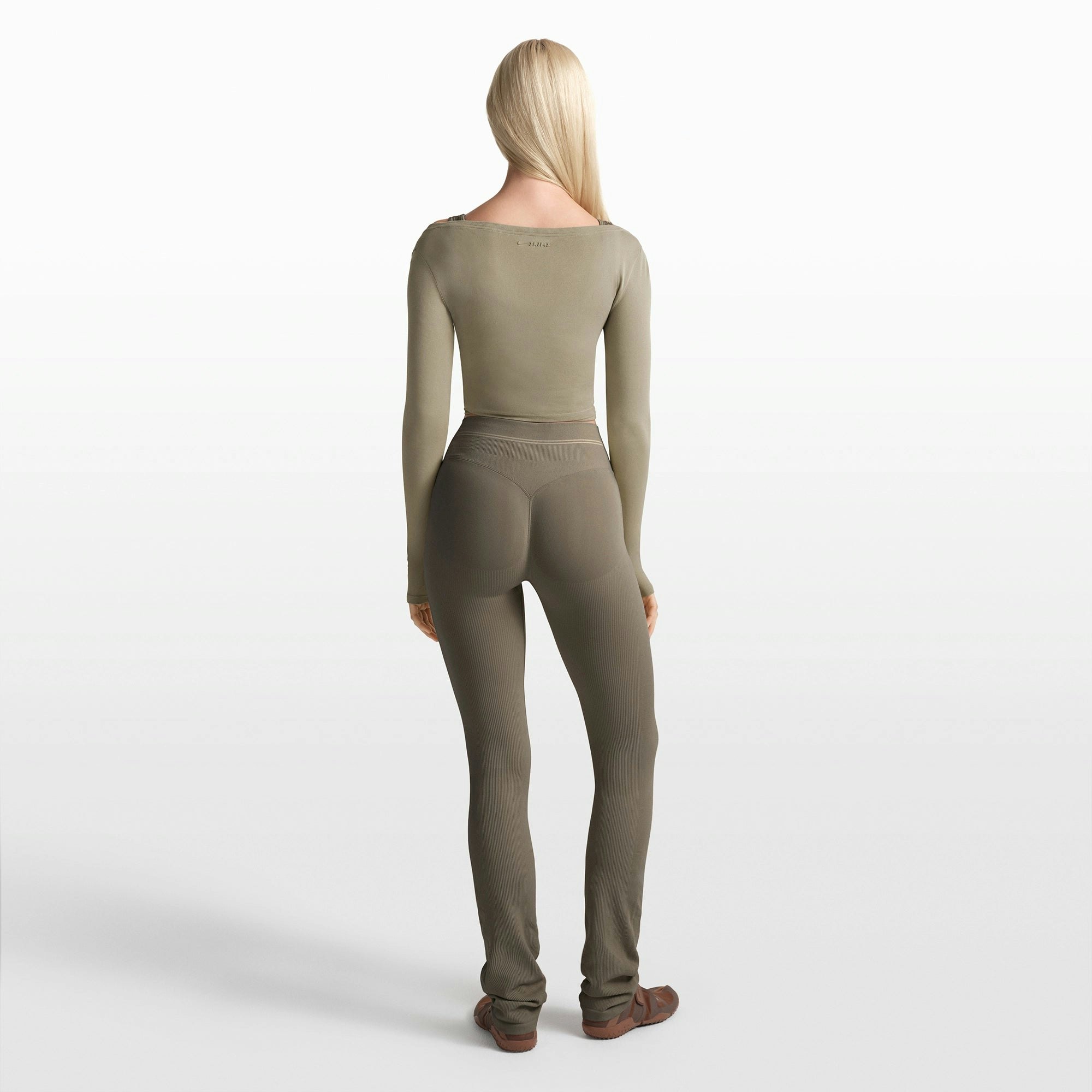 NikeSKIMS RIBBED SEAMLESS 34" STRAIGHT LEGGING | DUSTY OAKMOSS ON A MODEL FRONT VIEW @ | FOCUS: 0.0, 1.0, 0.9
