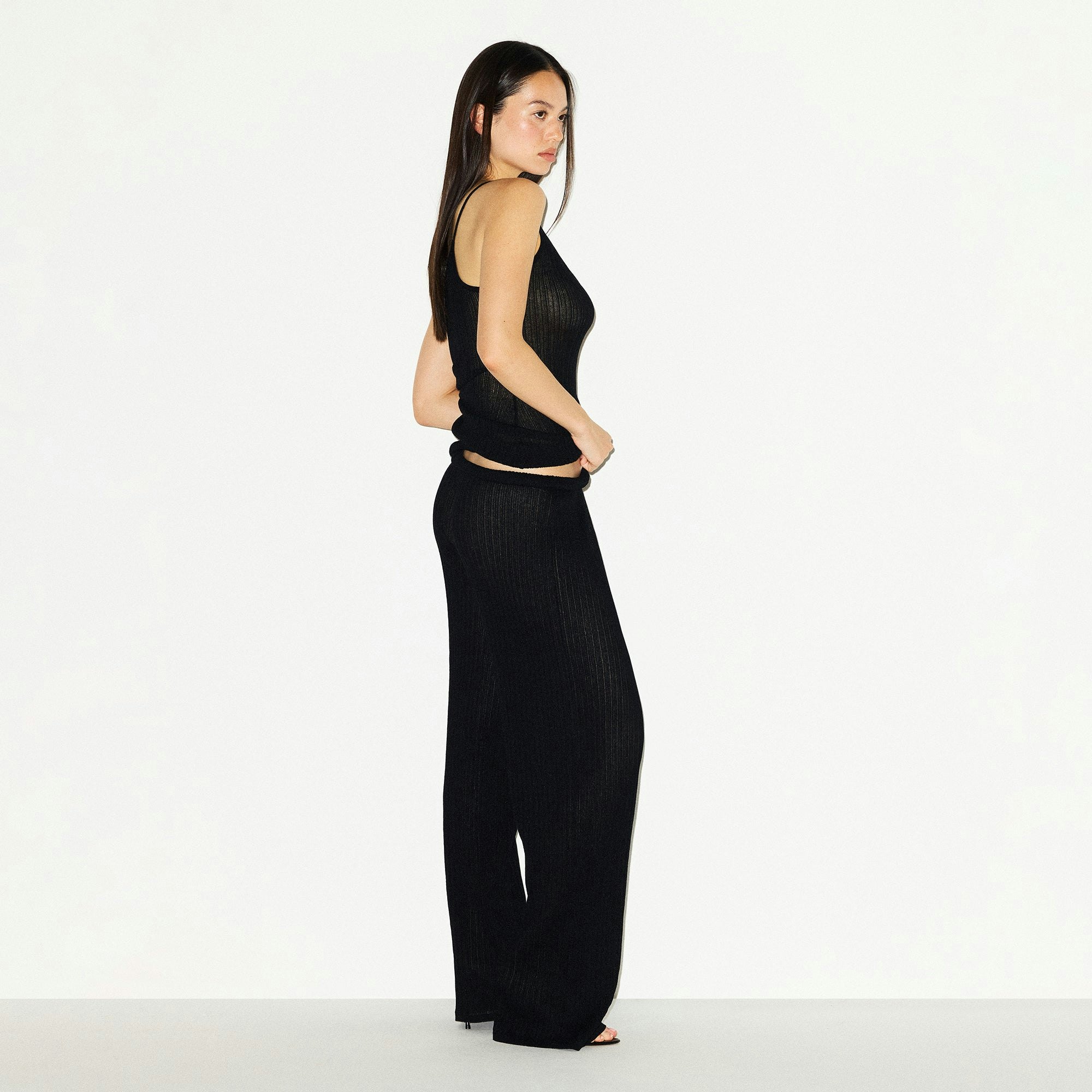 SHEER KNIT STRAIGHT LEG PANT | ONYX ON A MODEL SIDE VIEW @ | FOCUS: 0.0, 1.0, 0.9