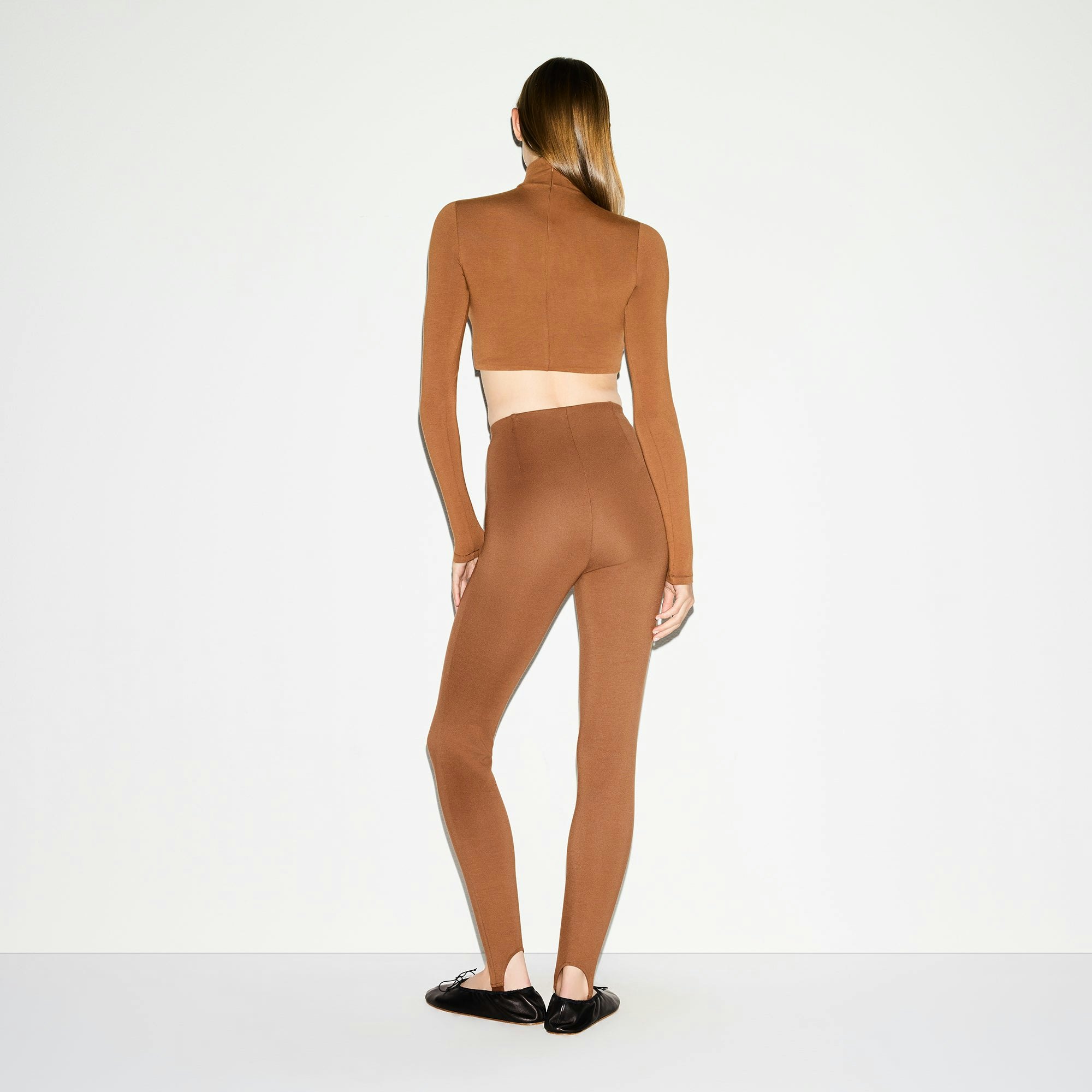 THE ESSENTIAL COLLECTION HIGH-WAISTED STIRRUP LEGGING | BISON ON A MODEL BACK VIEW @ | FOCUS: 0.0, 1.0, 0.9