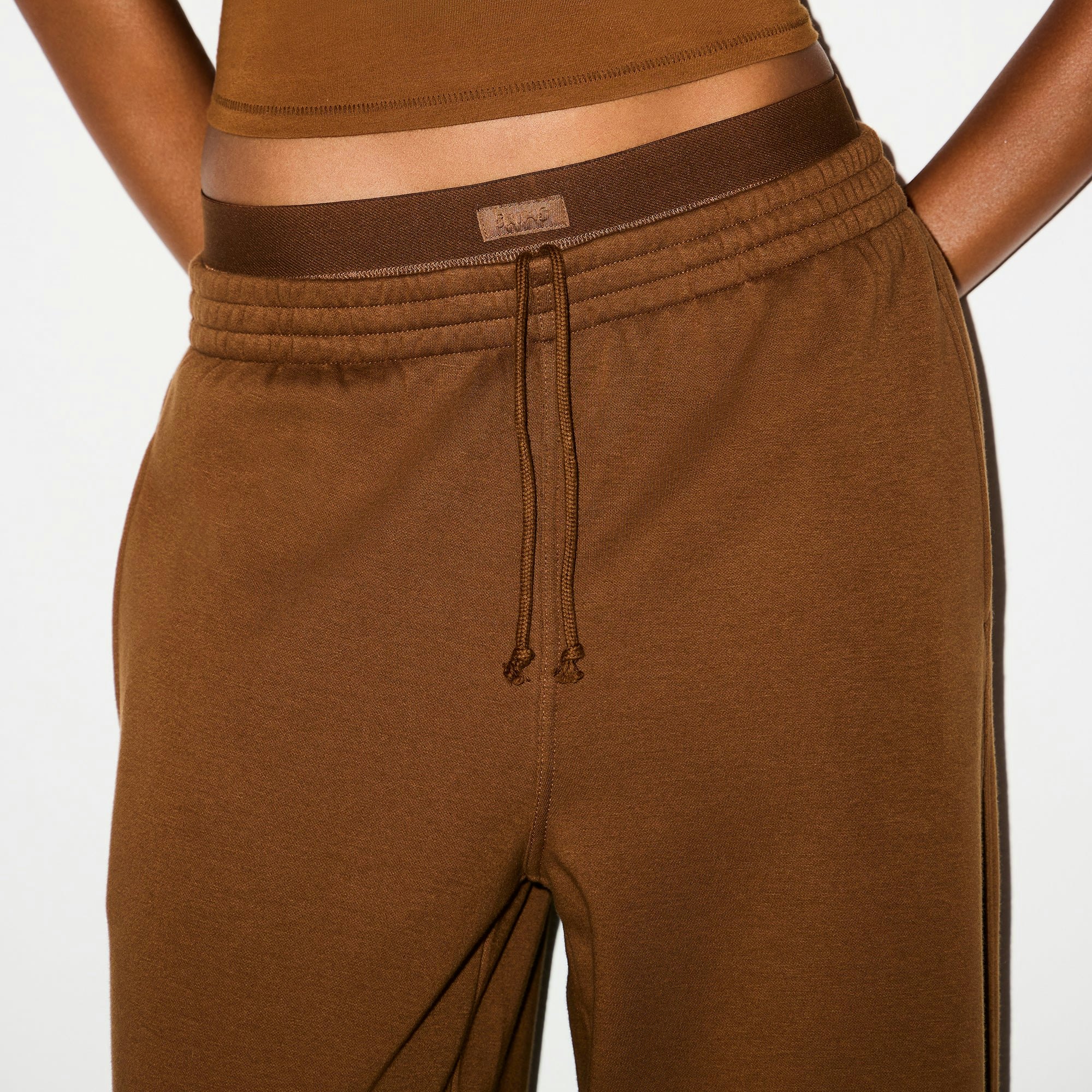 COTTON FLEECE OVERSIZED DOUBLE WAISTBAND PANT | BISON ON A MODEL FRONT VIEW @ | FOCUS: 0.0, 1.0, 0.9