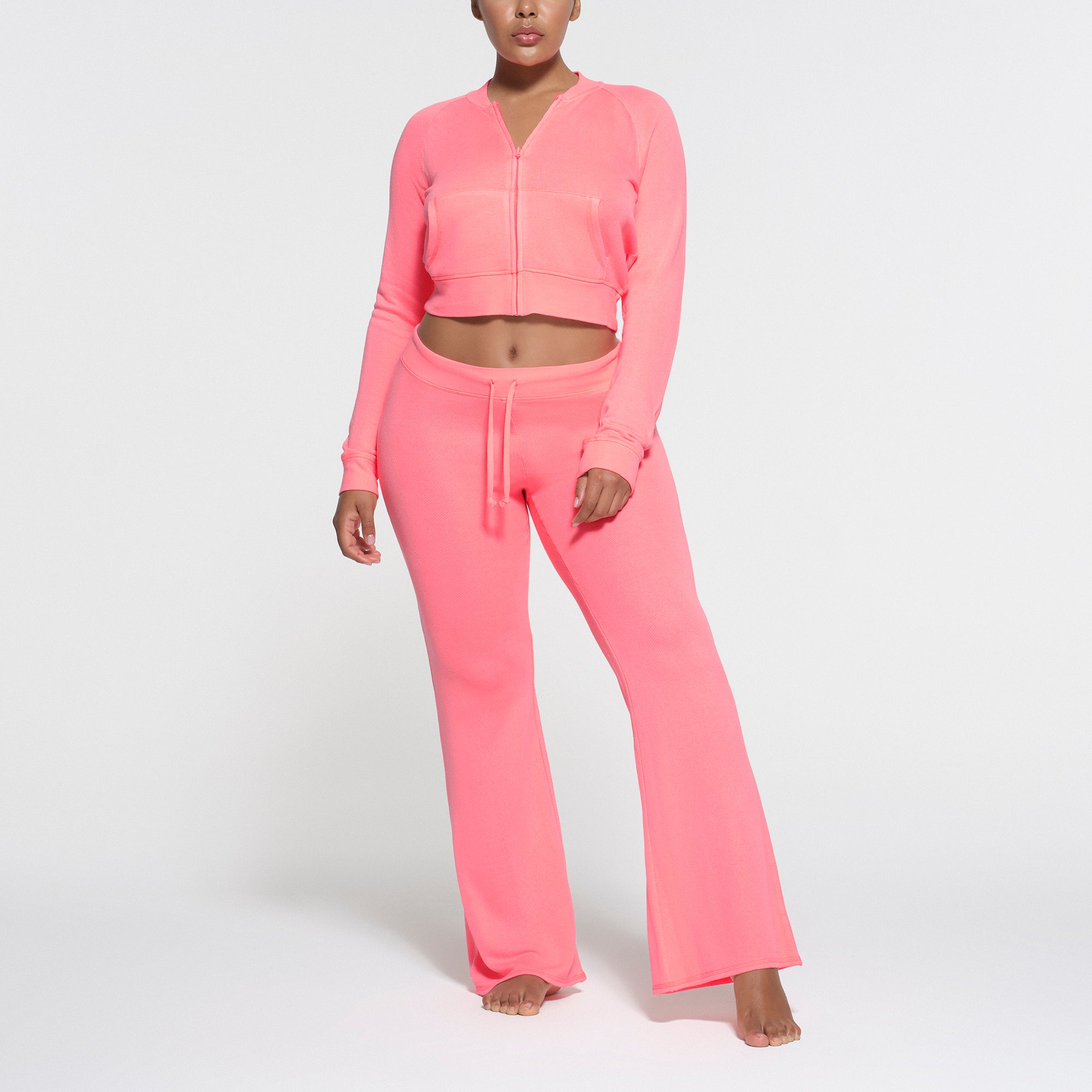 LIGHT FRENCH TERRY FLARE PANT | CORAL ON A MODEL FRONT VIEW
