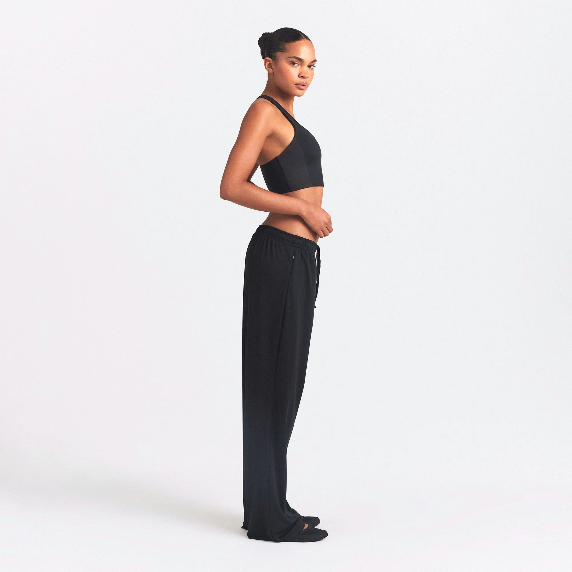 NikeSKIMS AIRY WIDE LEG PANT | OBSIDIAN ON A MODEL SIDE VIEW @ | FOCUS: 0.0, 1.0, 0.9