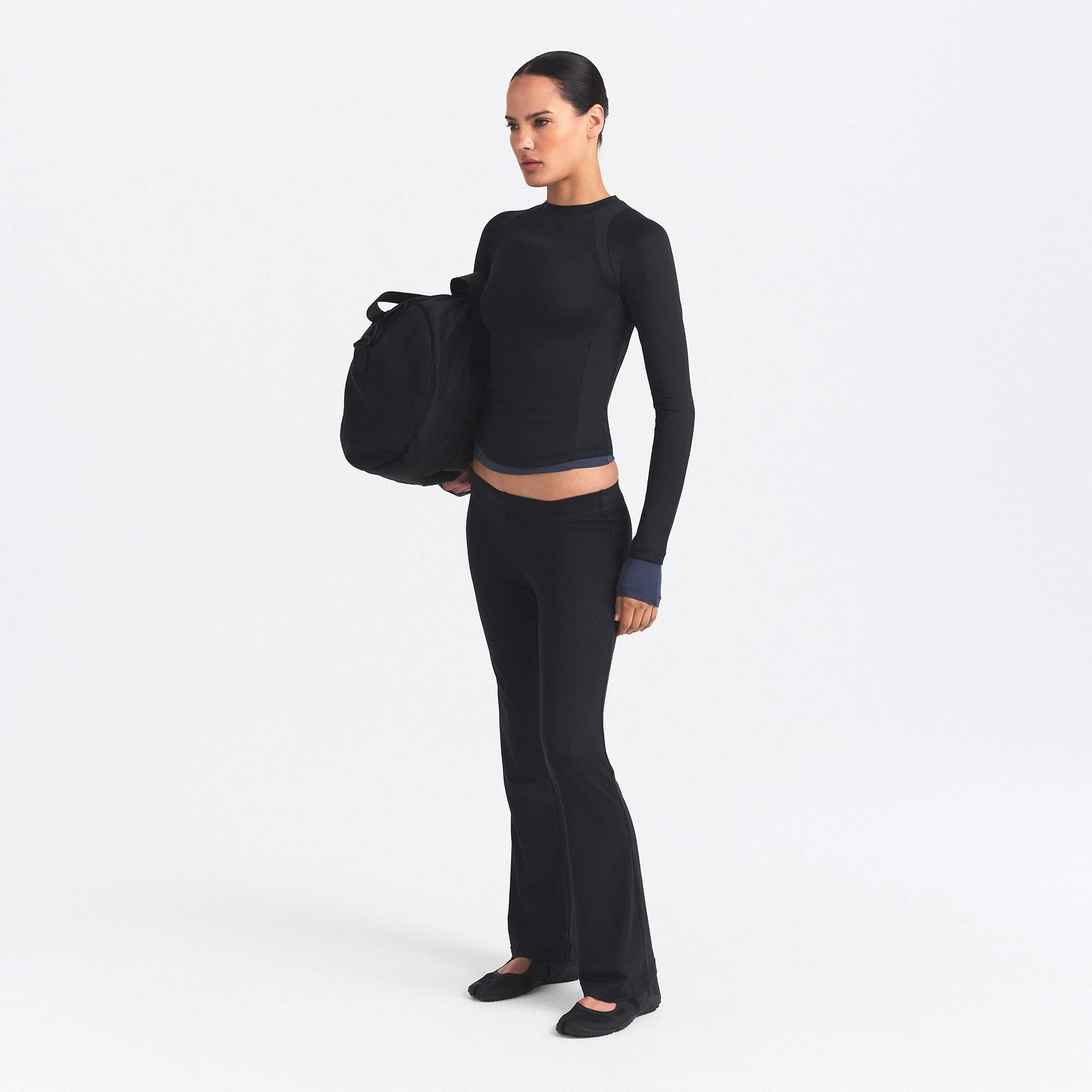 NikeSKIMS AIRY STRAIGHT LEG PANT | OBSIDIAN ON A MODEL SIDE VIEW @ | FOCUS: 0.0, 1.0, 0.9