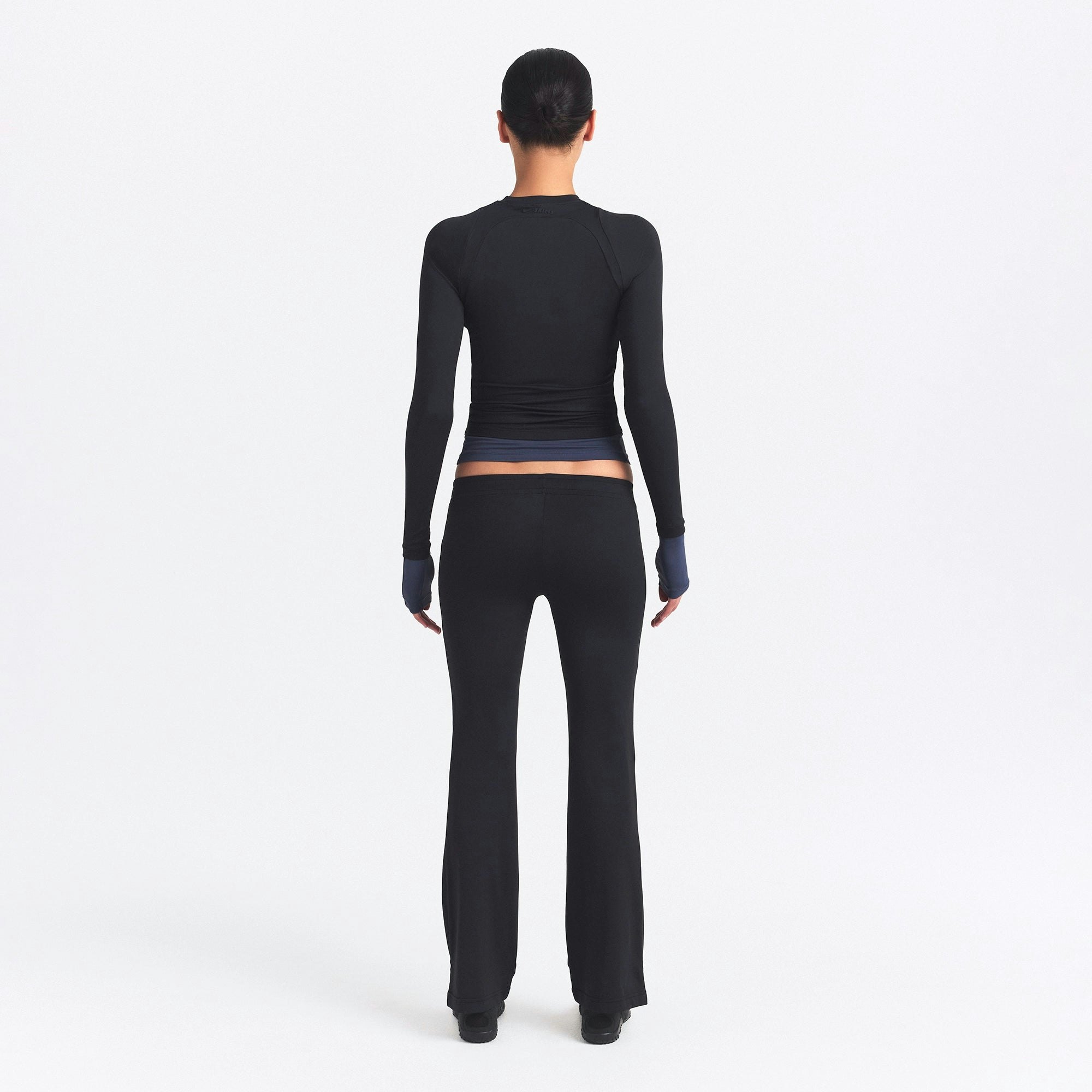 NikeSKIMS AIRY STRAIGHT LEG PANT | OBSIDIAN ON A MODEL SIDE VIEW @ | FOCUS: 0.0, 1.0, 0.9