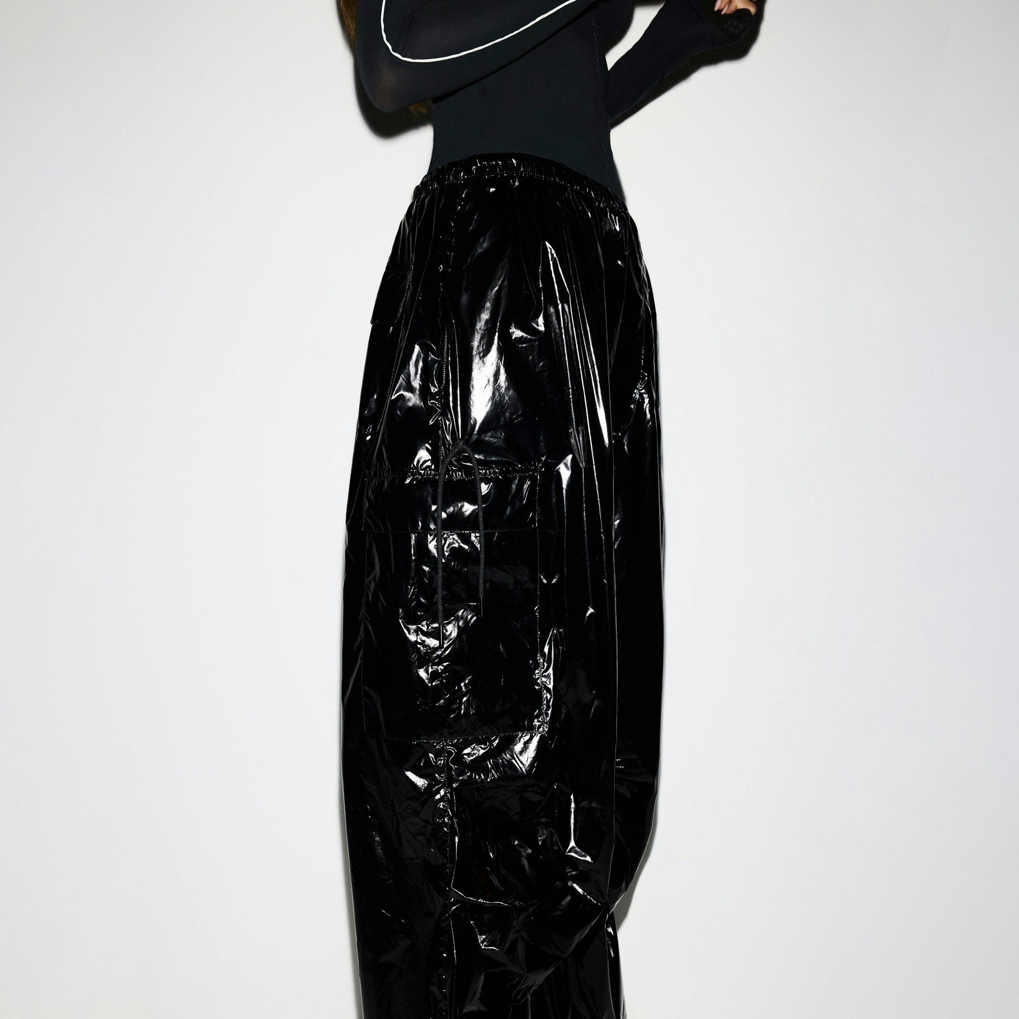 NikeSKIMS SHINY NYLON CARGO PANT | OBSIDIAN ON A MODEL SIDE VIEW @ | FOCUS: 0.0, 1.0, 0.9