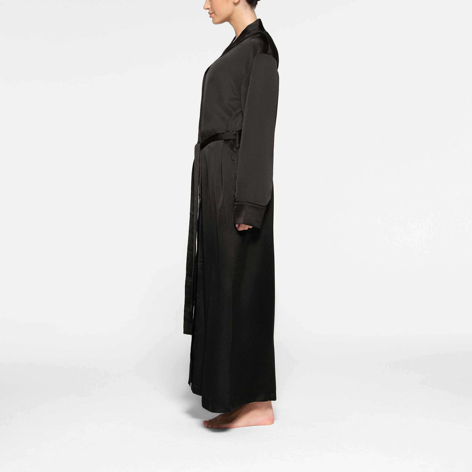 SKIMS SPORTY SATIN LONG ROBE WORN BY A MODEL IN SIDE VIEW