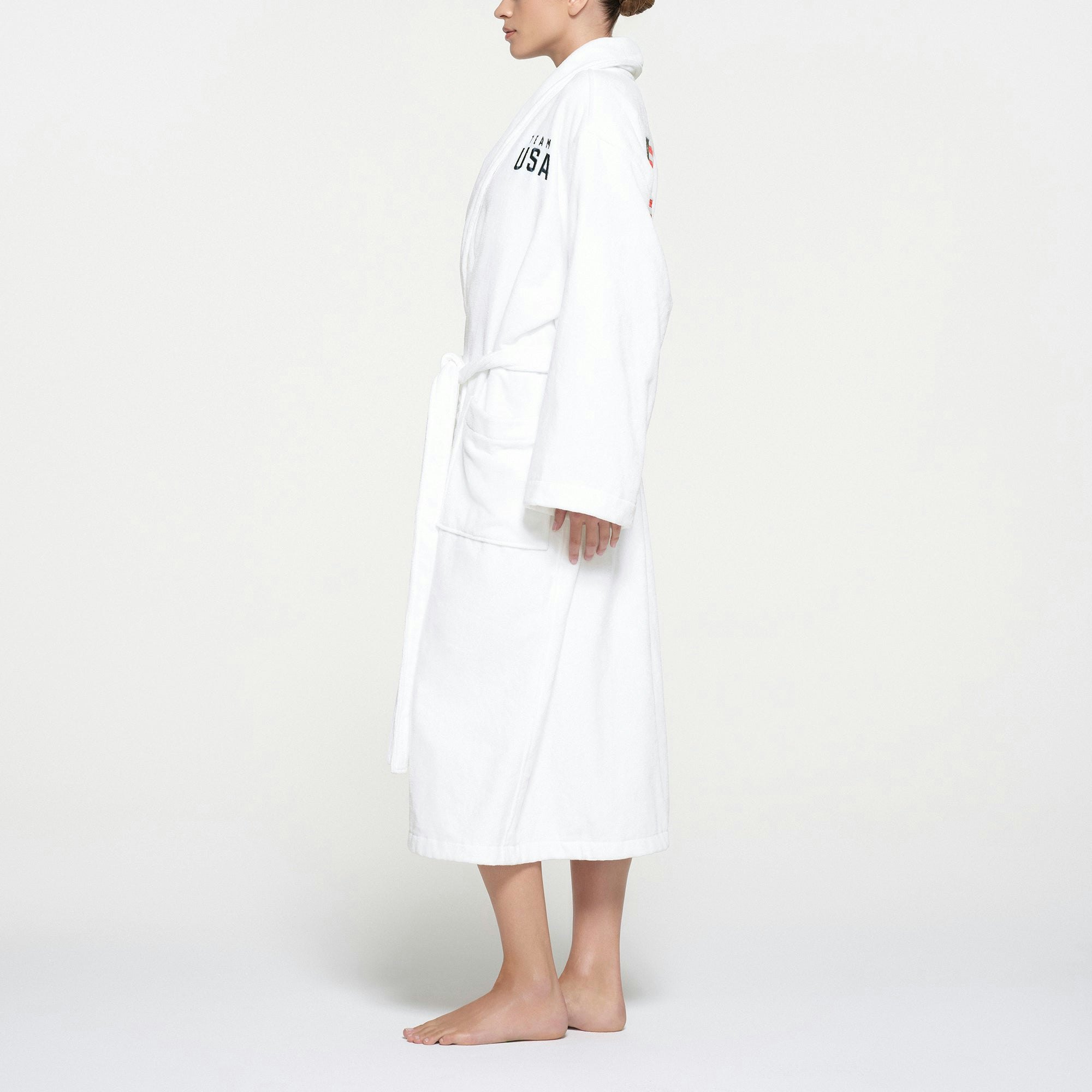 SKIMS FOR TEAM USA TERRY OLYMPIC UNISEX ROBE | WHITE ON A MODEL SIDE VIEW