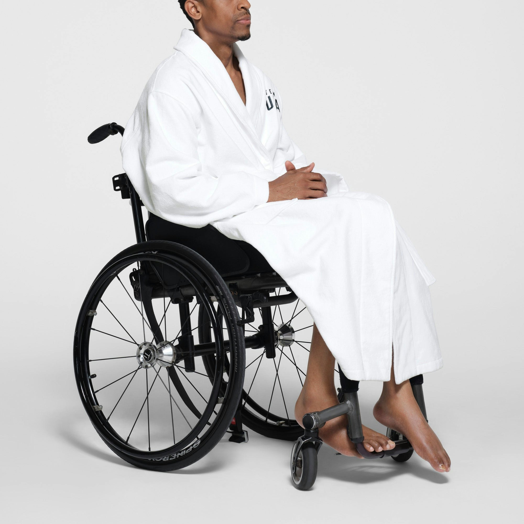 SKIMS FOR TEAM USA TERRY PARALYMPIC UNISEX ROBE | WHITE ON A MODEL SIDE VIEW
