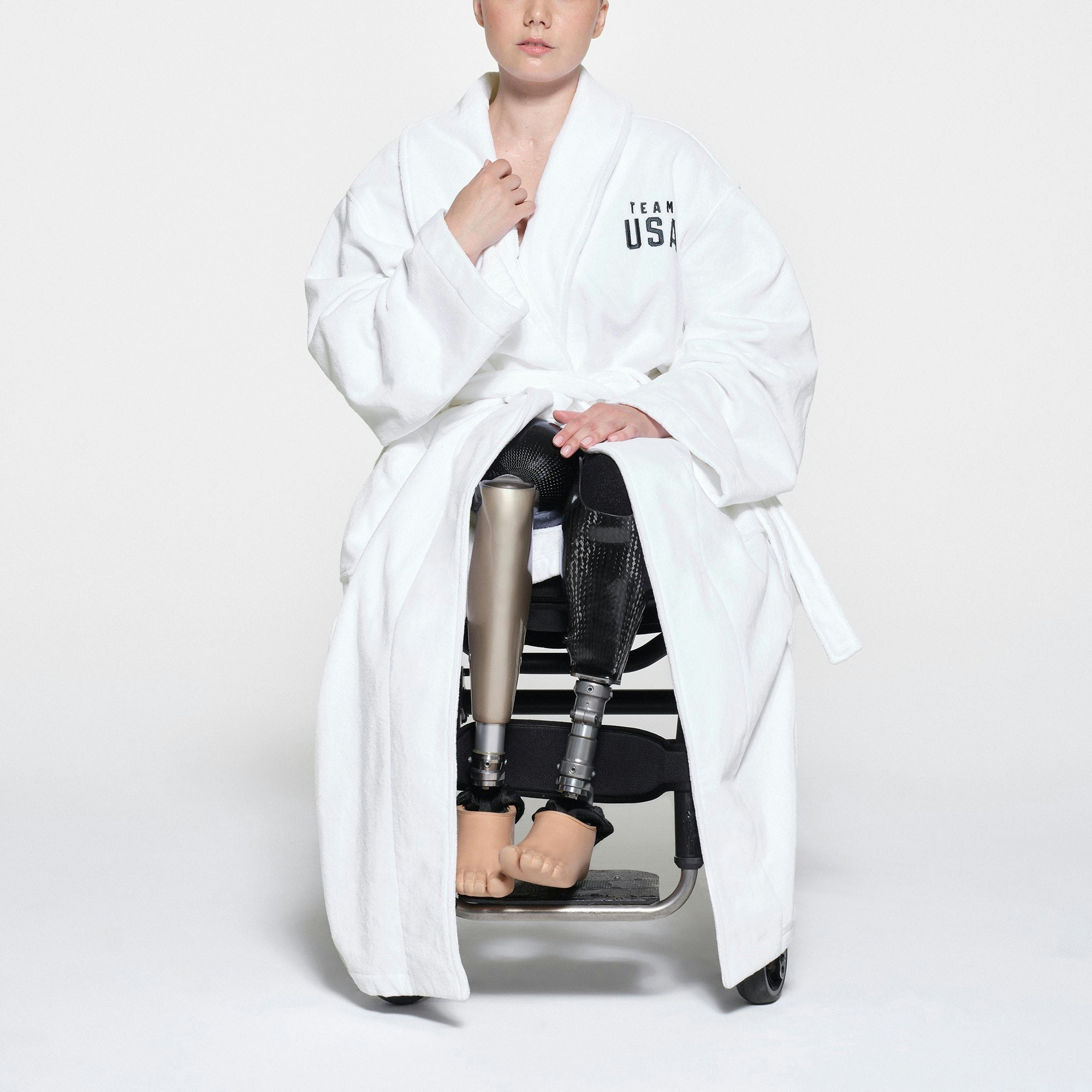 SKIMS FOR TEAM USA TERRY PARALYMPIC UNISEX ROBE | WHITE ON A MODEL FRONT VIEW | FOCUS: 0.1, 1, 0.9
