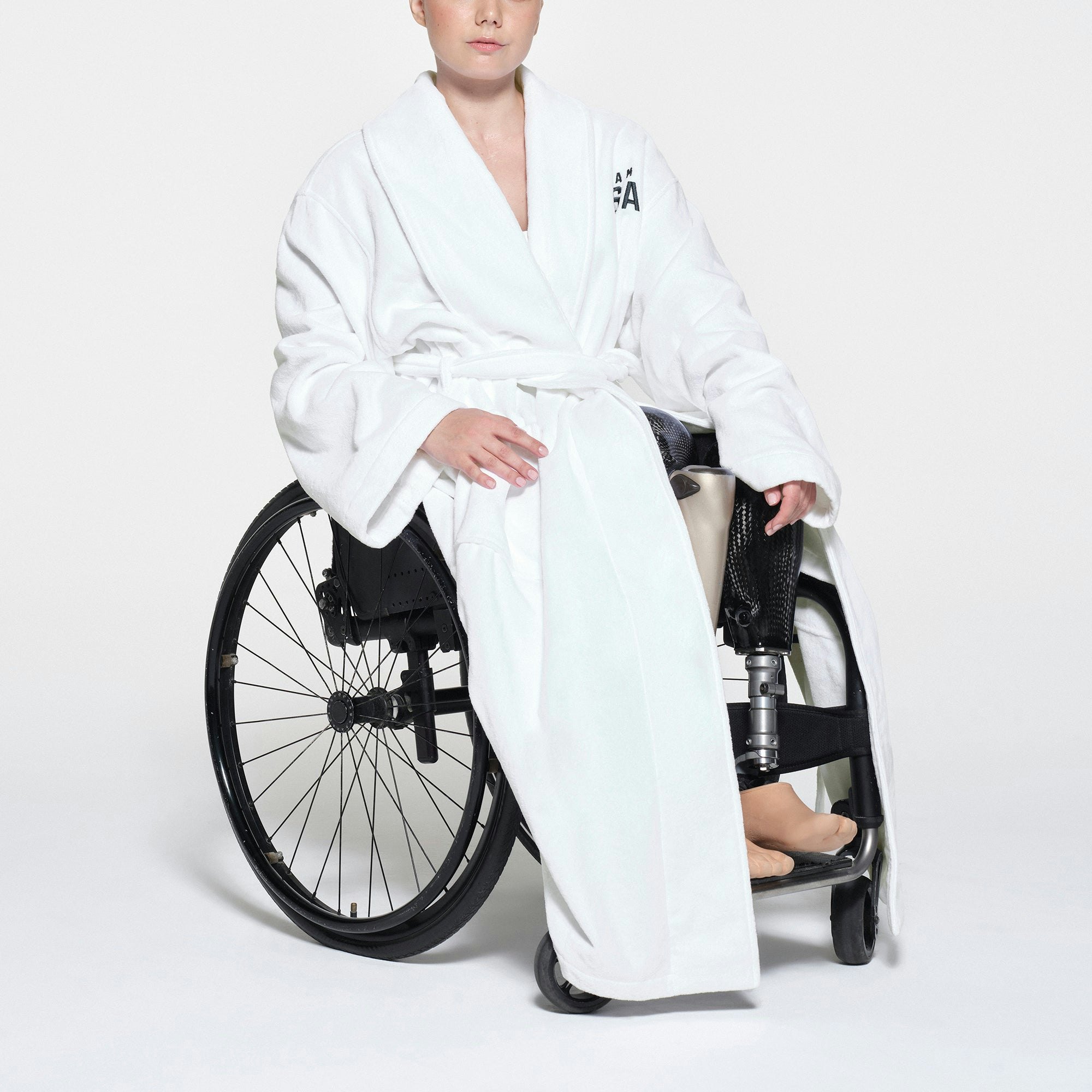 SKIMS FOR TEAM USA TERRY PARALYMPIC UNISEX ROBE | WHITE ON A MODEL SIDE VIEW