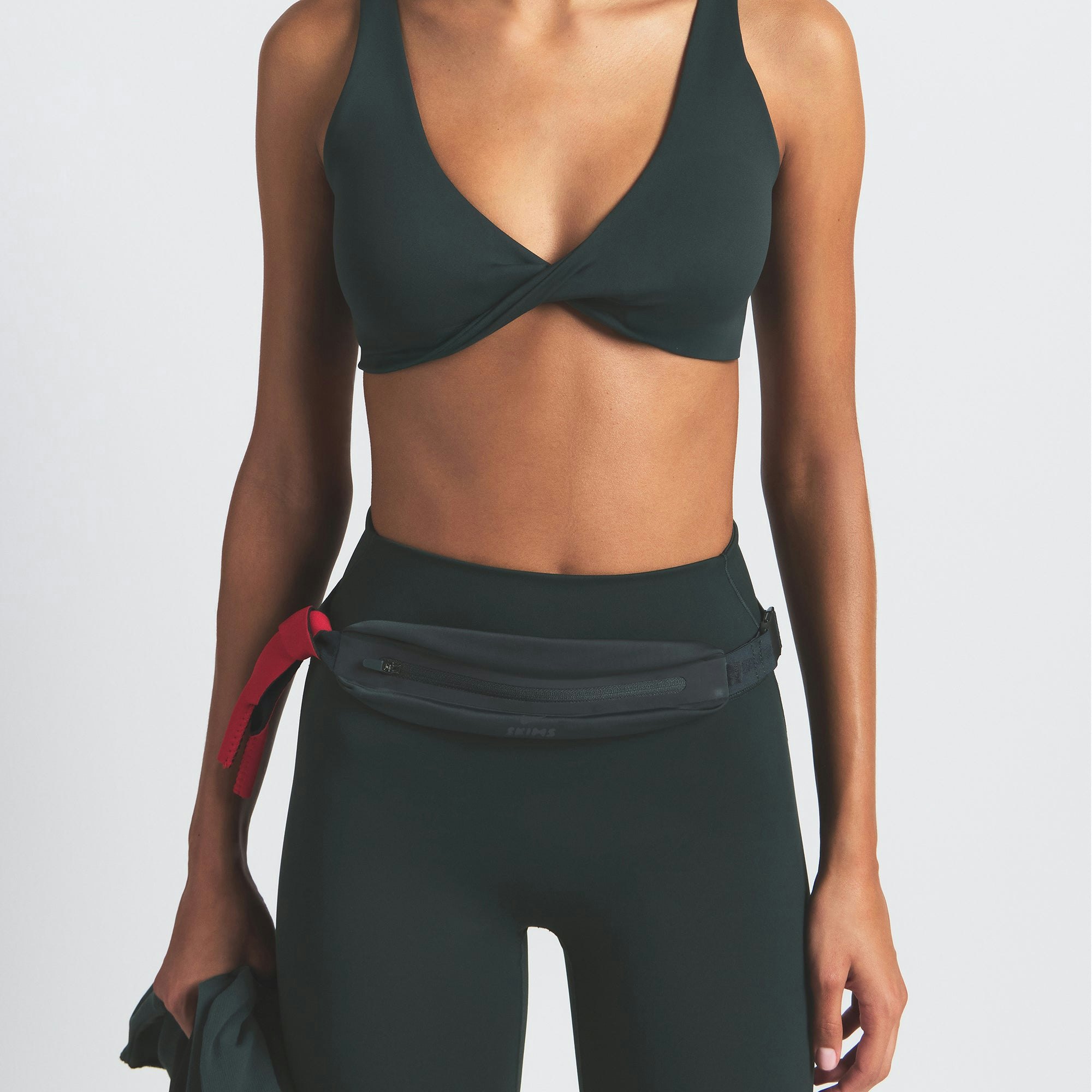 NikeSKIMS SLIM WAISTPACK | DARK TEAL ON A MODEL FRONT VIEW @ | FOCUS: 0.0, 1.0, 0.9