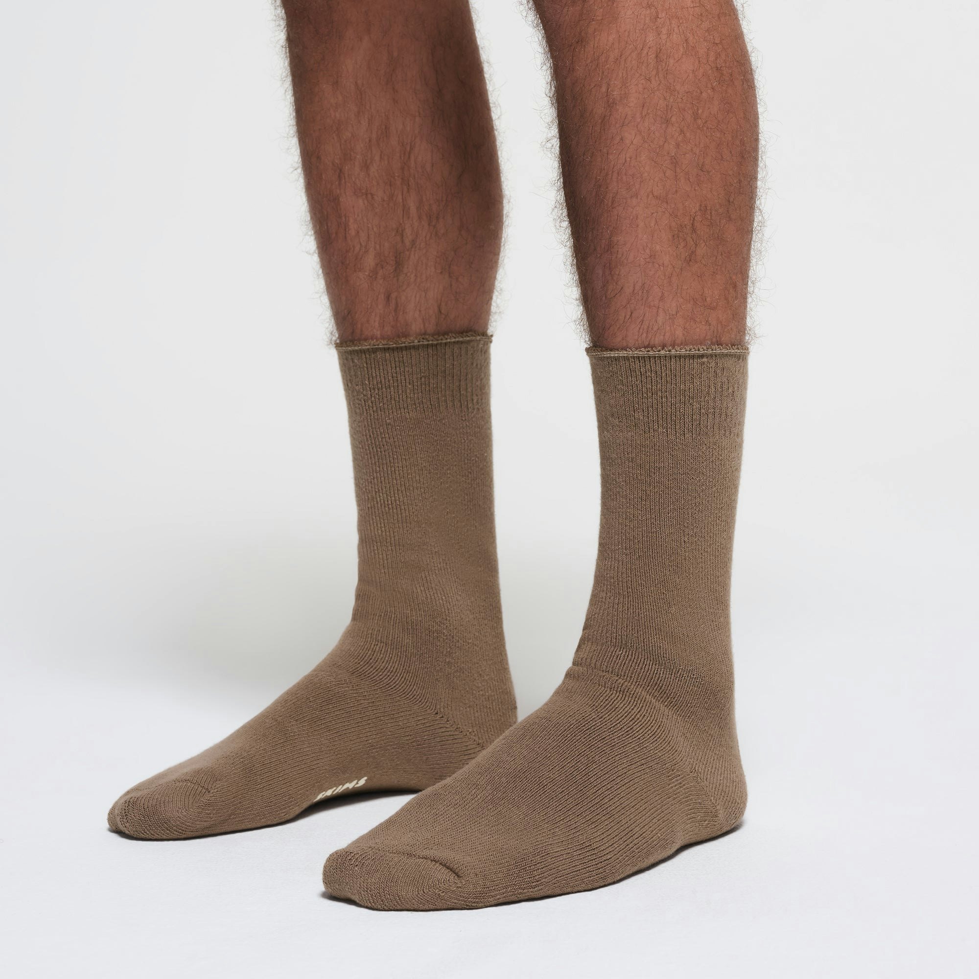 MENS LOUNGE SOCK | TRUFFLE ON A MODEL SIDE VIEW