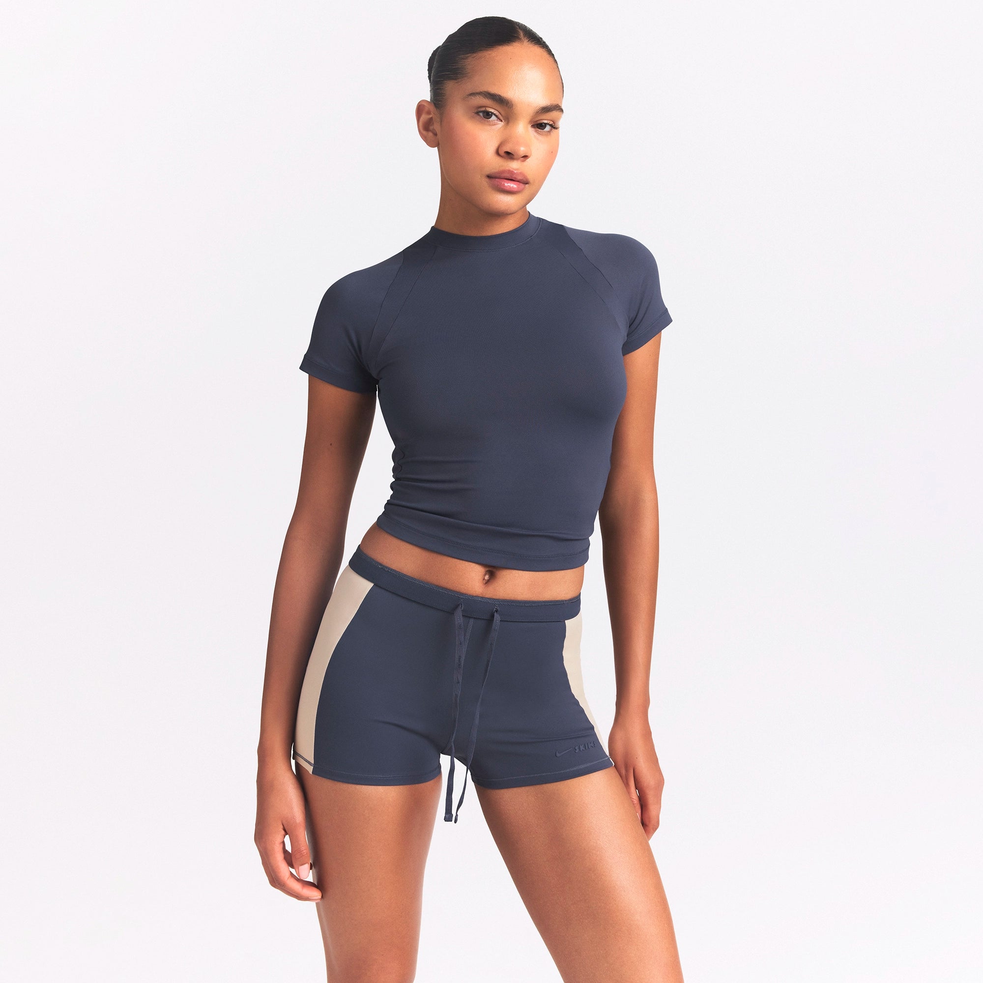 NikeSKIMS MATTE AND SHINE DRAWCORD 2" SHORT | DEEP ROYAL/STONE ON A MODEL SIDE VIEW @ | FOCUS: 0.0, 1.0, 0.9