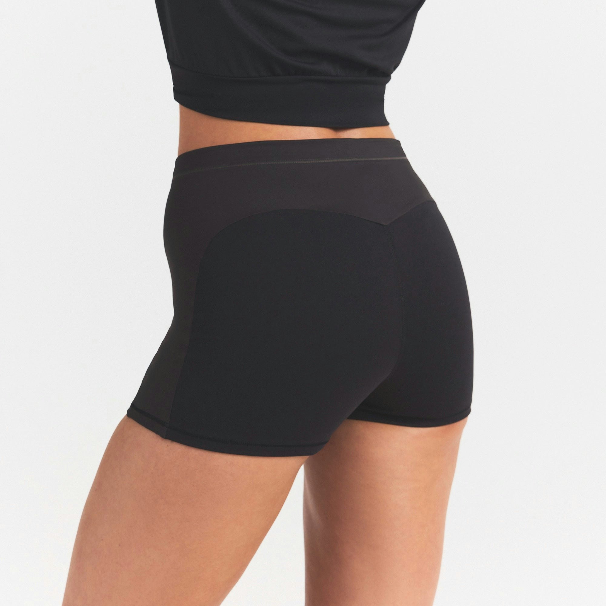 NikeSKIMS MATTE AND SHINE DRAWCORD 2" SHORT | OBSIDIAN/IGNEOUS ON A MODEL SIDE VIEW @ | FOCUS: 0.0, 1.0, 0.9