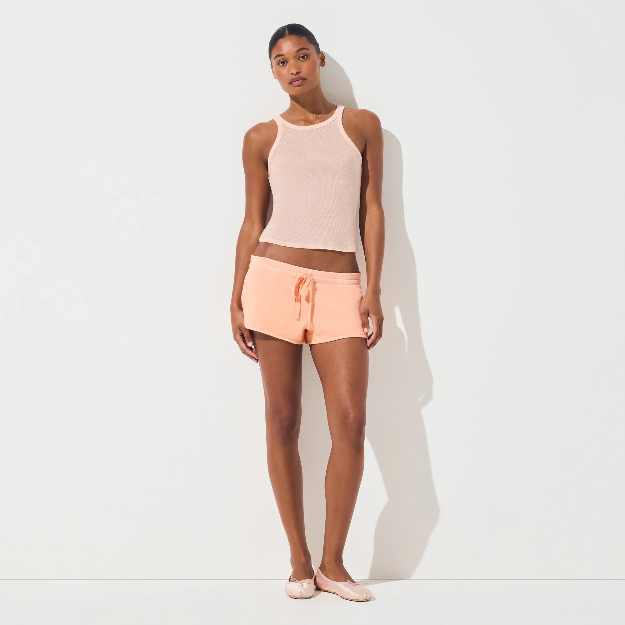 FRENCH TERRY SHORT SHORT | CANTALOUPE ON A MODEL FRONT VIEW | FOCUS: 0.0, 1.0, 0.9