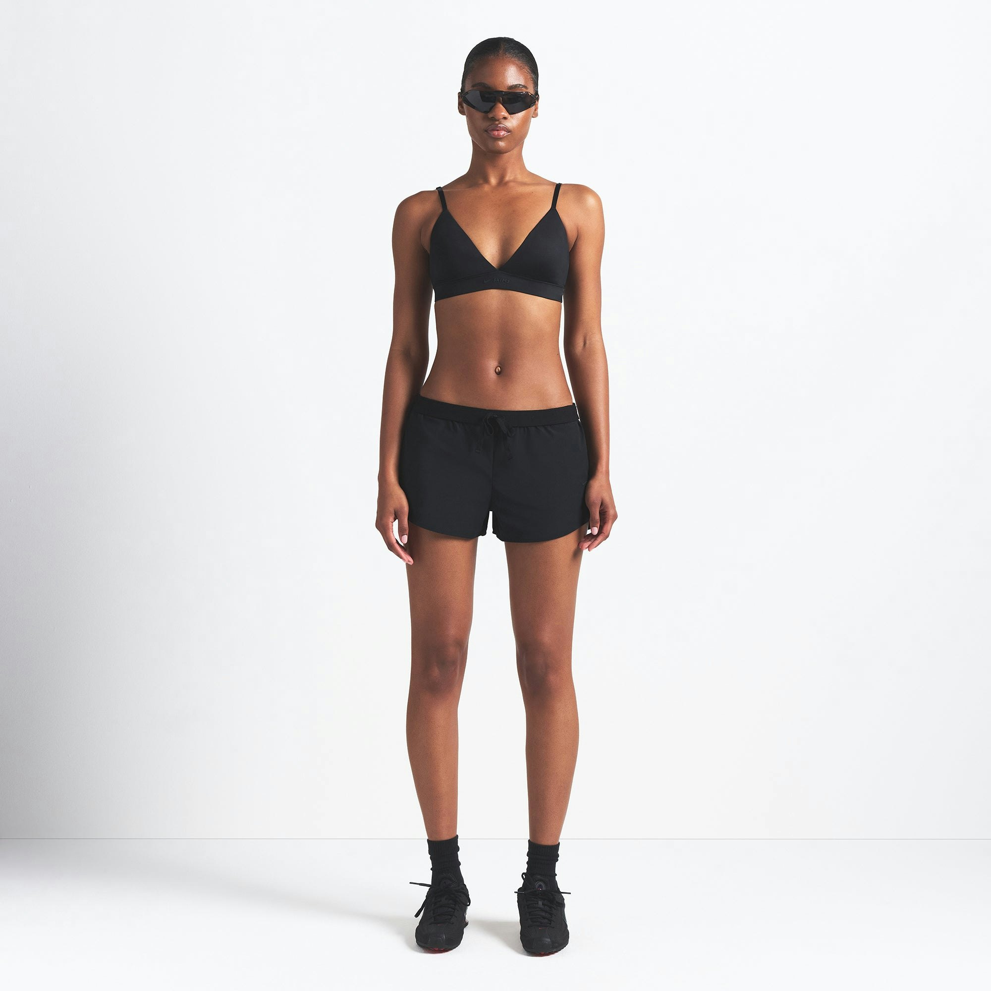 NikeSKIMS WOVEN NYLON 2.5" RUNNER SHORT | OBSIDIAN ON A MODEL FRONT VIEW @ | FOCUS: 0.0, 1.0, 0.9