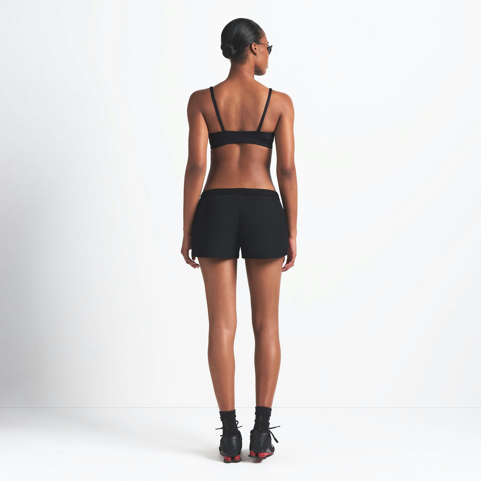 NikeSKIMS WOVEN NYLON 2.5" RUNNER SHORT | OBSIDIAN ON A MODEL BACK VIEW @ | FOCUS: 0.0, 1.0, 0.9